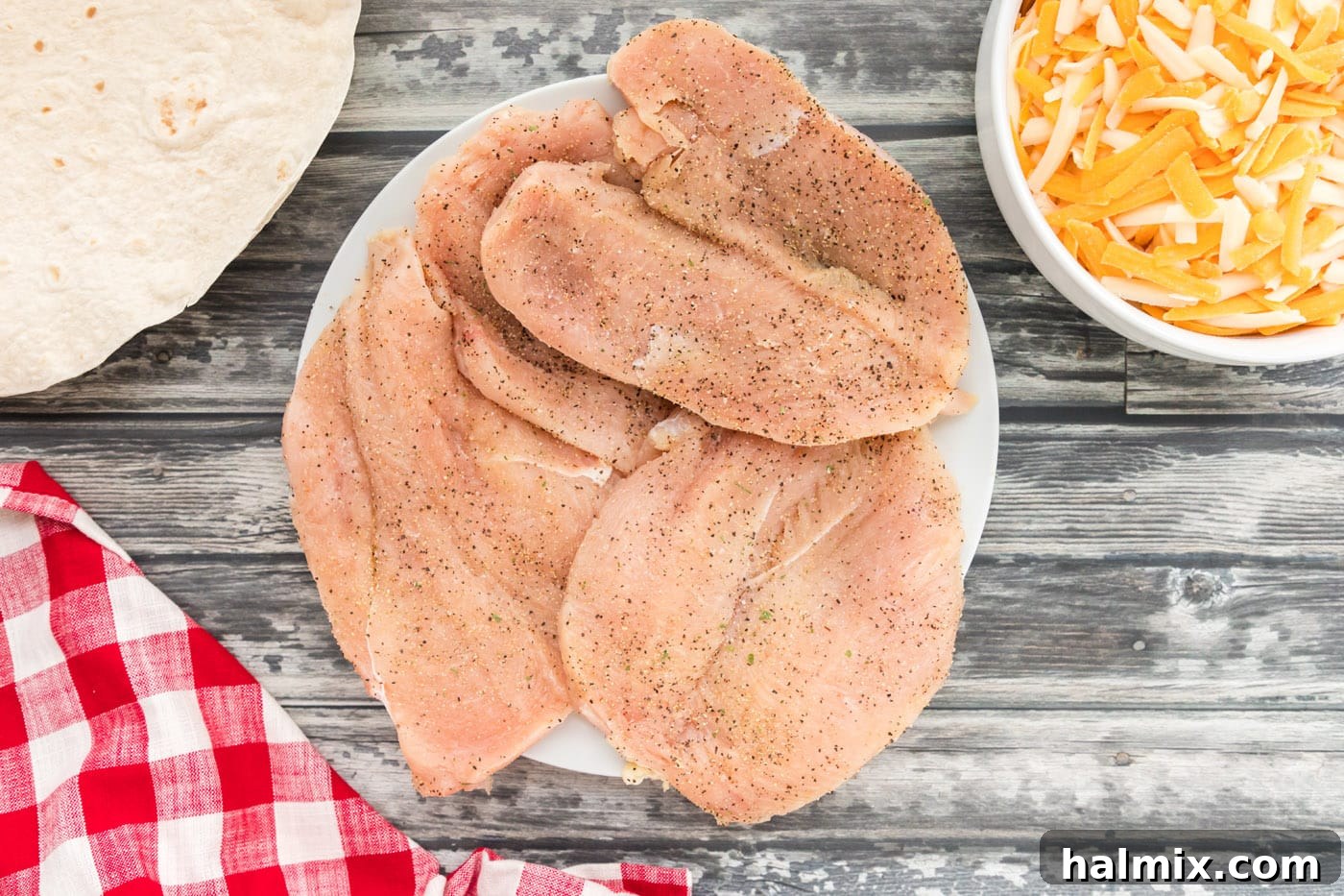 Grilled Chicken & Cheese Fiesta 5 Seasoned chicken breasts on a plate ready for grilling