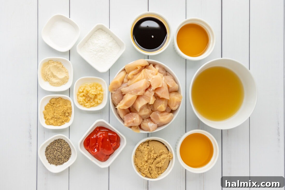 A selection of fresh ingredients for Bourbon Chicken laid out on a cutting board