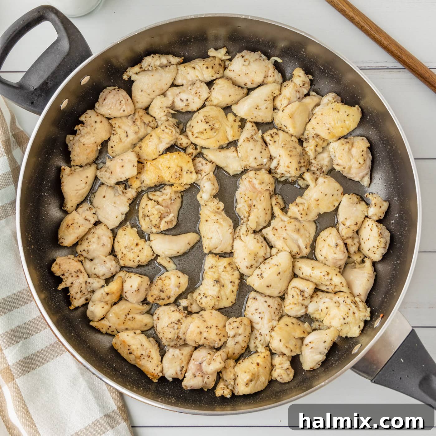 Chicken cooking and browning in a skillet