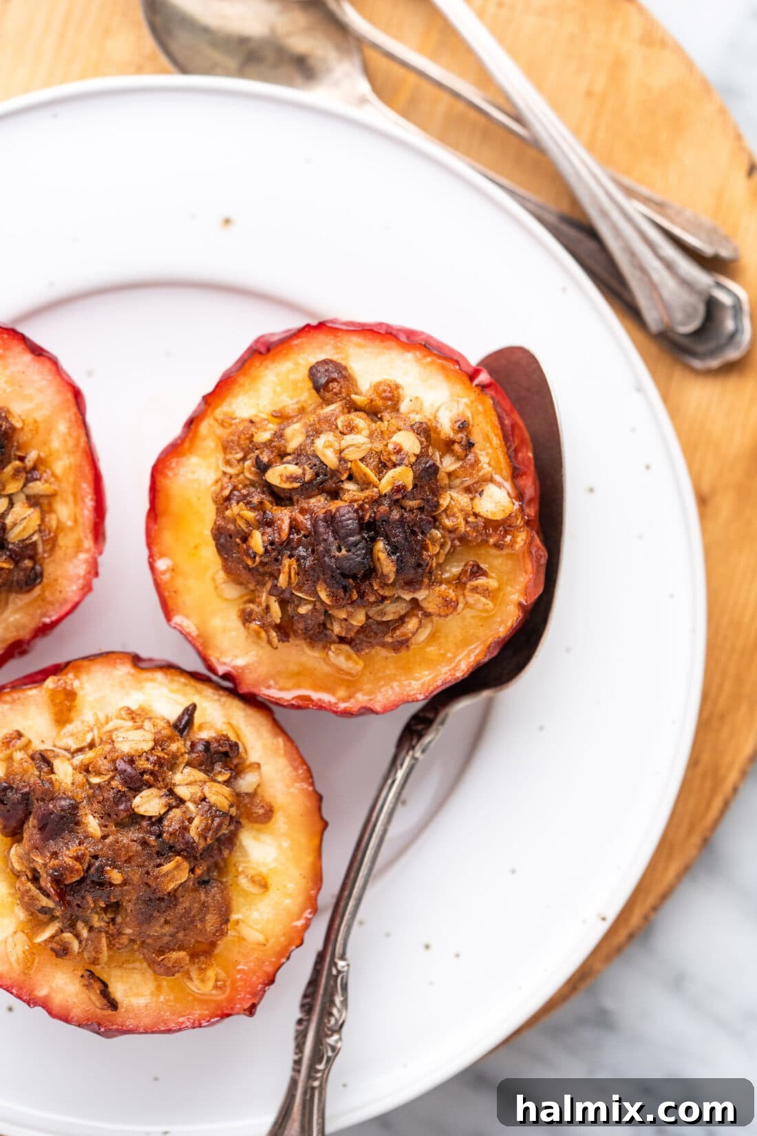 Air Fried Apple Delights 2 Air Fryer Baked Apples on a white plate, garnished with a sprinkle of cinnamon.