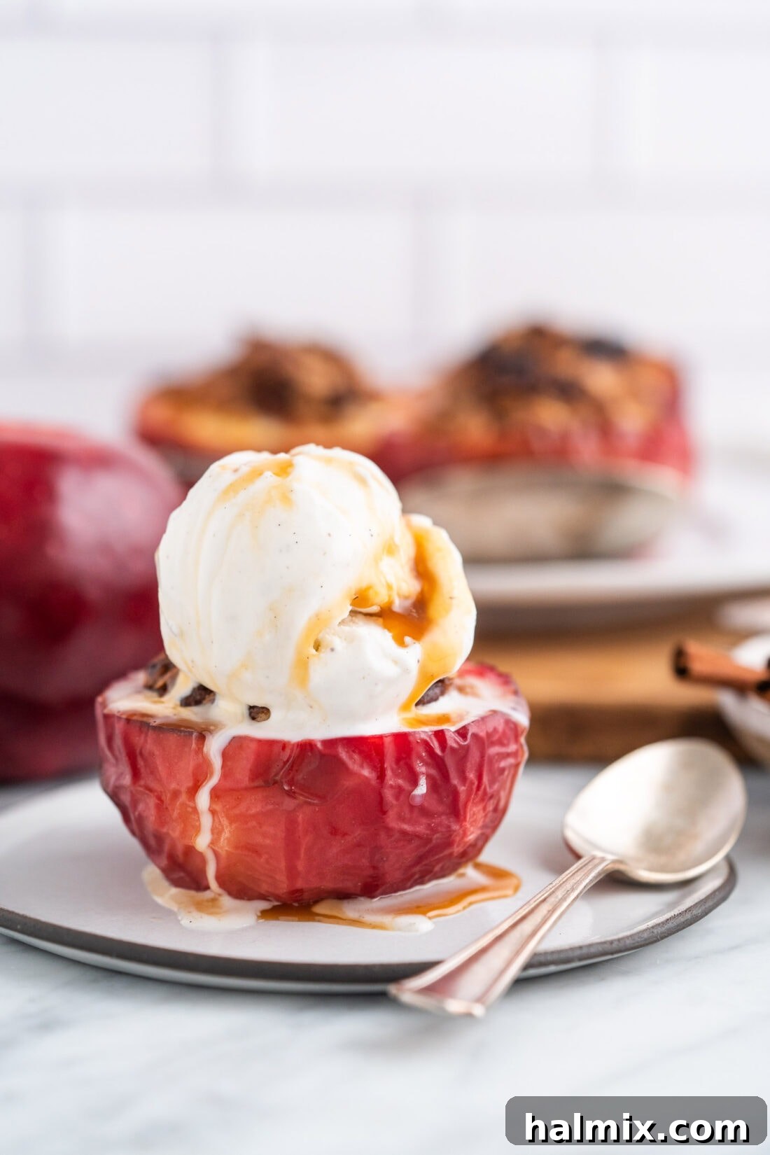 Air Fried Apple Delights 12 Air Fryer Baked Apple with a scoop of vanilla ice cream and a drizzle of caramel sauce on top.