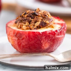 Air Fried Apple Delights 13 Air Fryer Baked Apples, showing a close-up of the perfectly cooked apple with its golden oat topping.