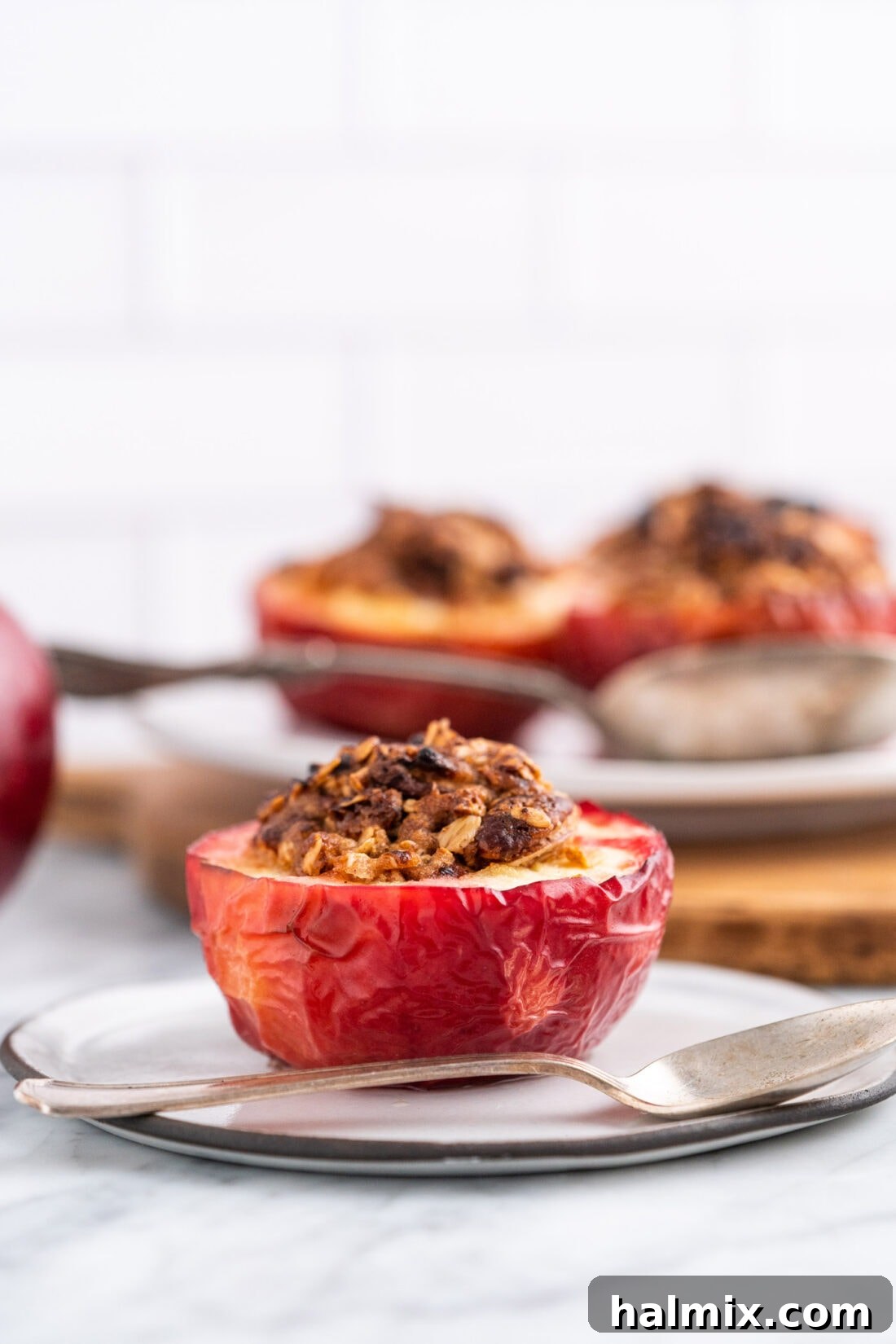 Air Fried Apple Delights 3 Air Fryer Baked Apple on plate, showing the golden oat and pecan topping.