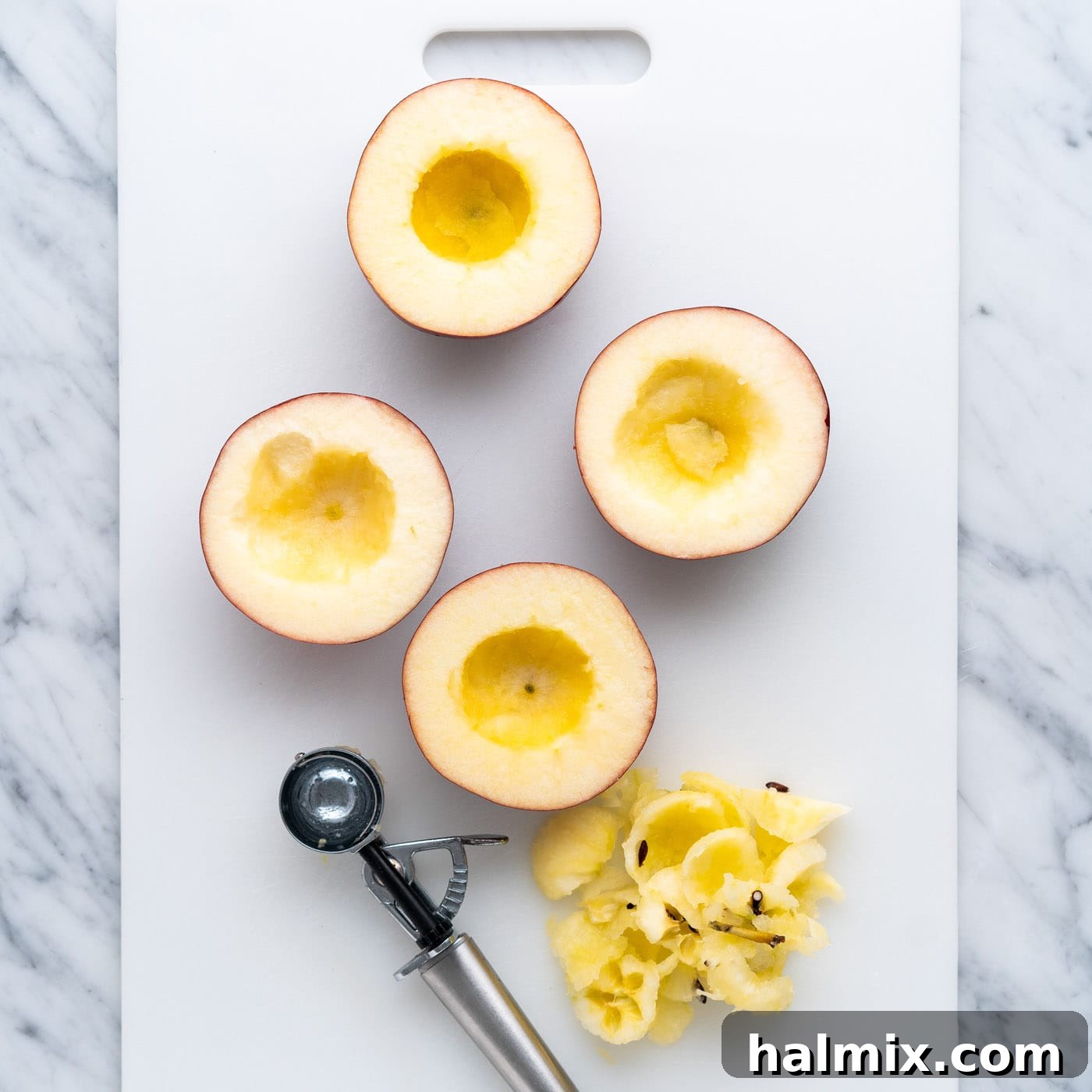 Air Fried Apple Delights 6 Close-up of perfectly cored apple halves using a melon baller, ready for filling.