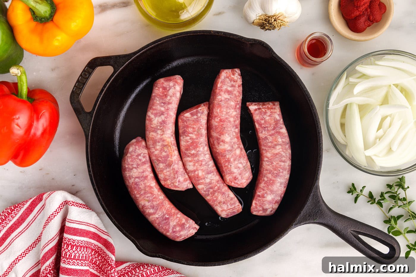 Italian sausage browning in a cast iron skillet