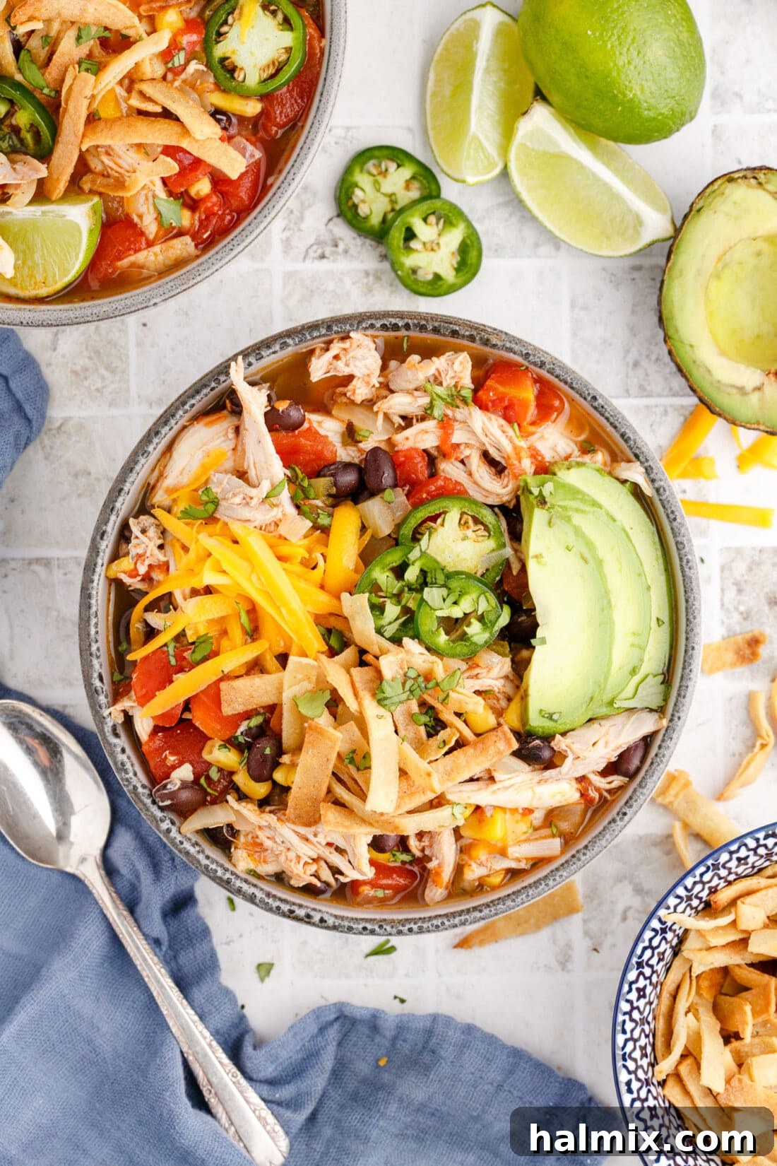 Hearty bowl of Chicken Tortilla Soup topped with fresh cilantro and lime