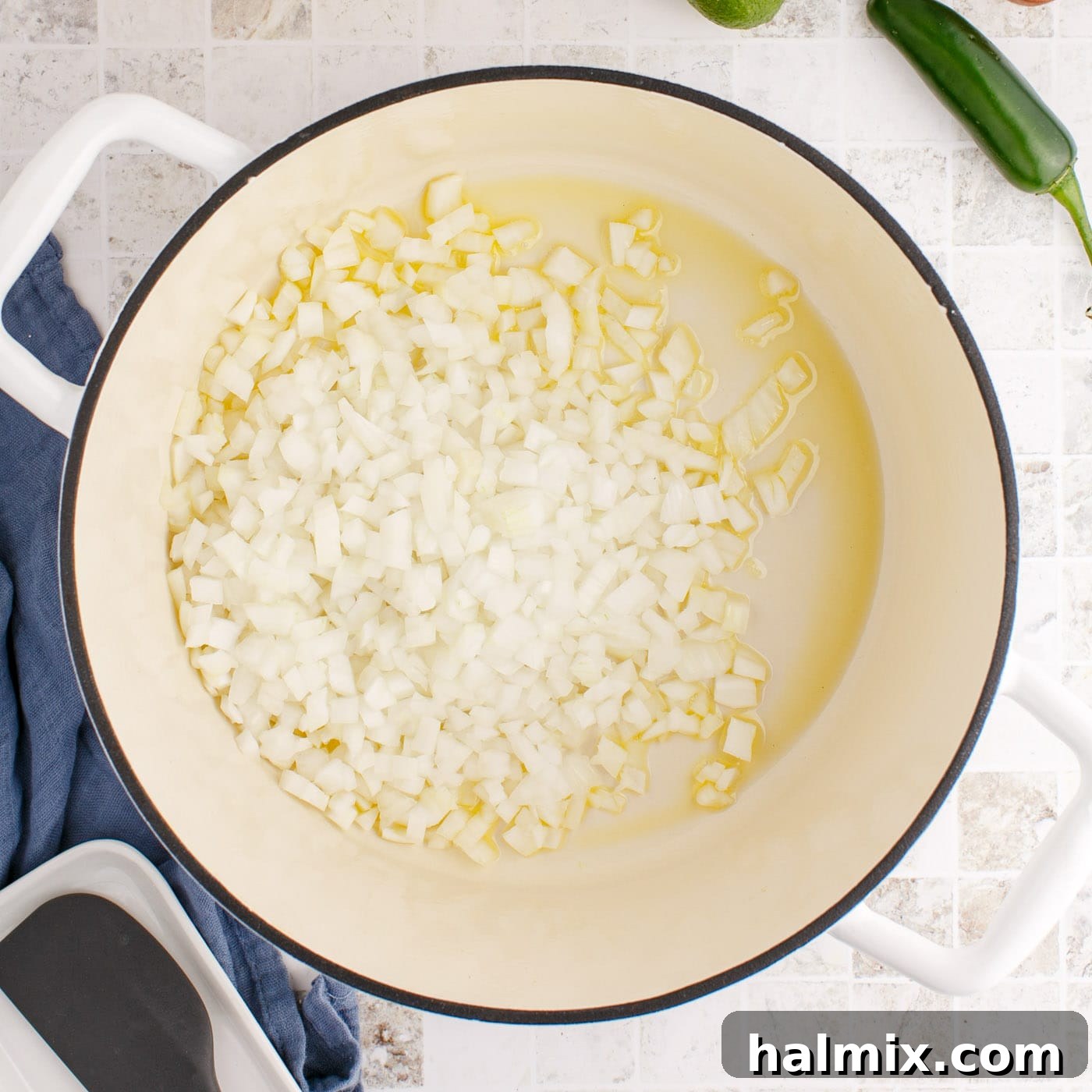Diced onion cooking in olive oil in a Dutch oven