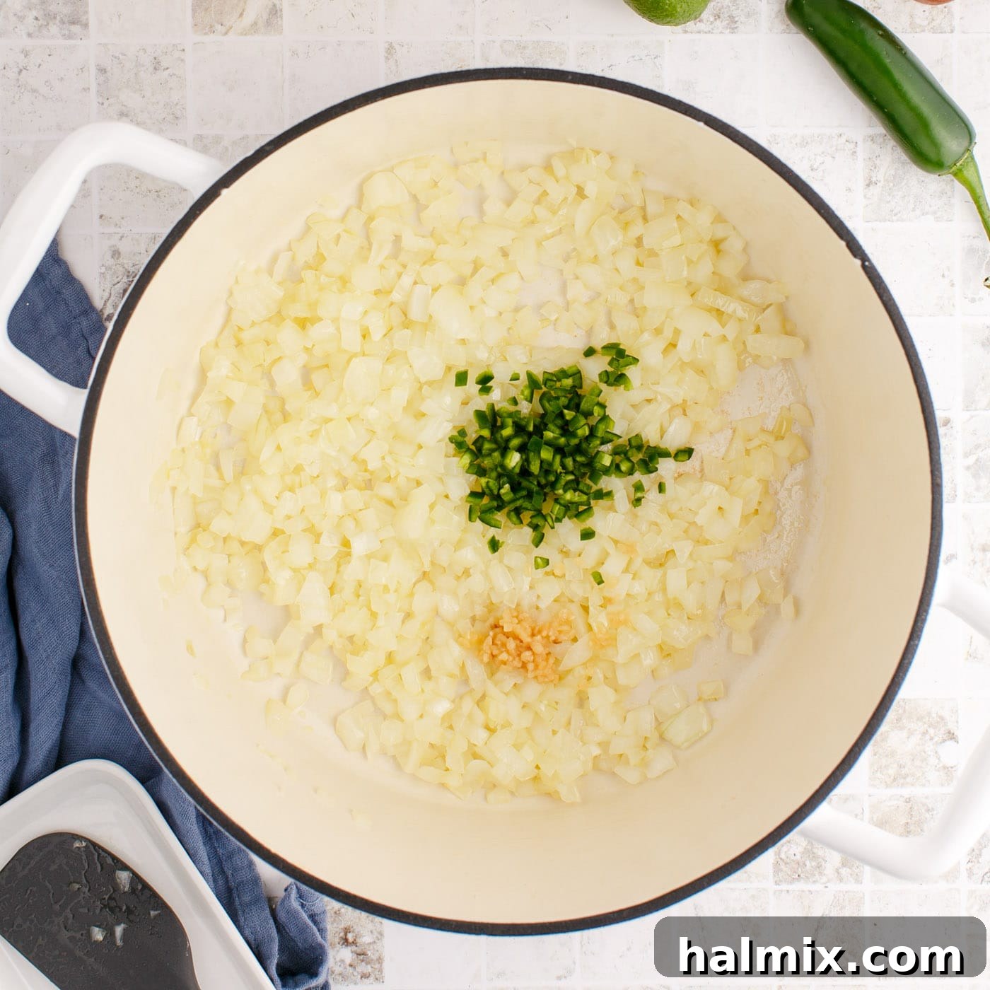 Jalapeno, onion, and garlic sautéing together in a stockpot
