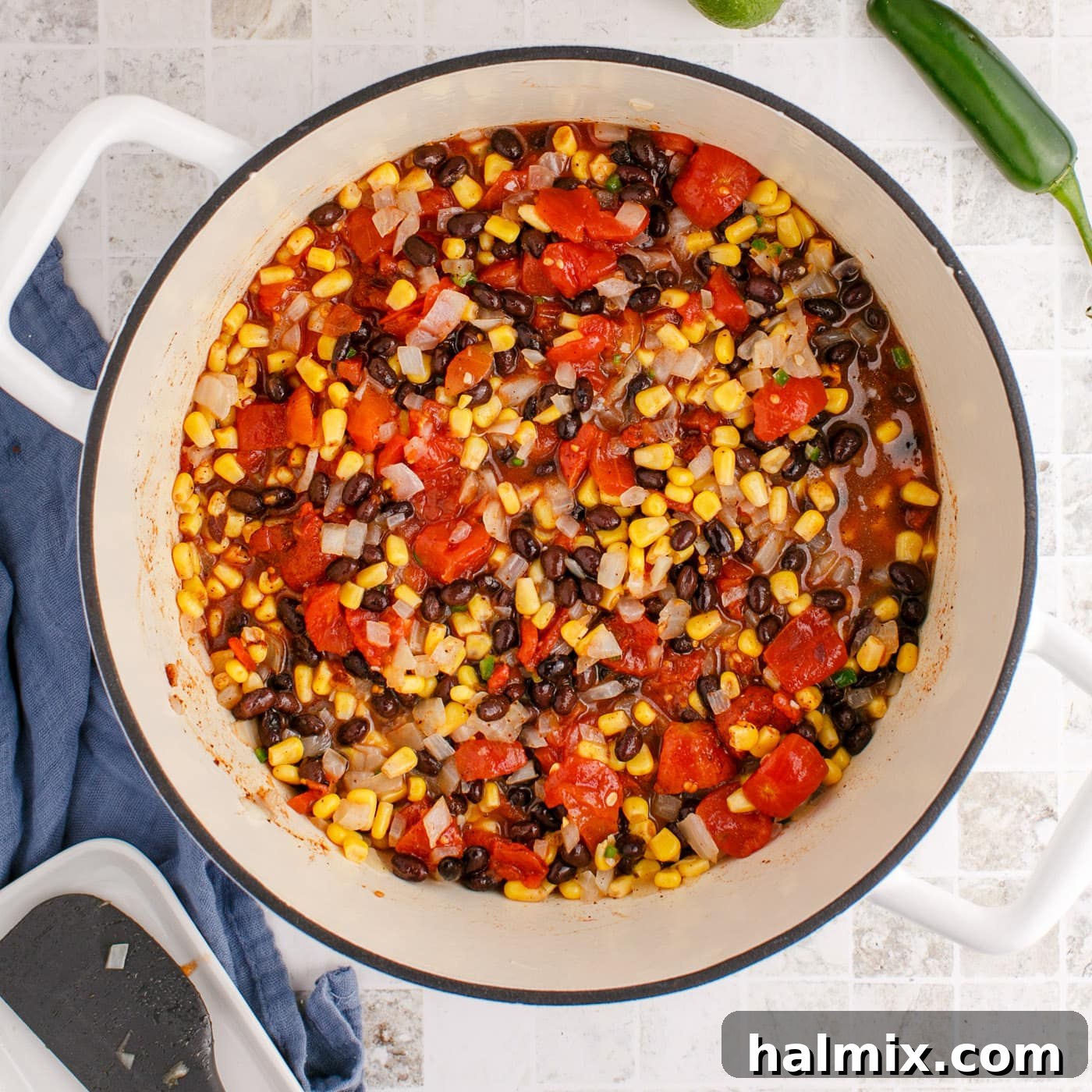 Chicken tortilla soup ingredients simmering in chicken stock in a pot