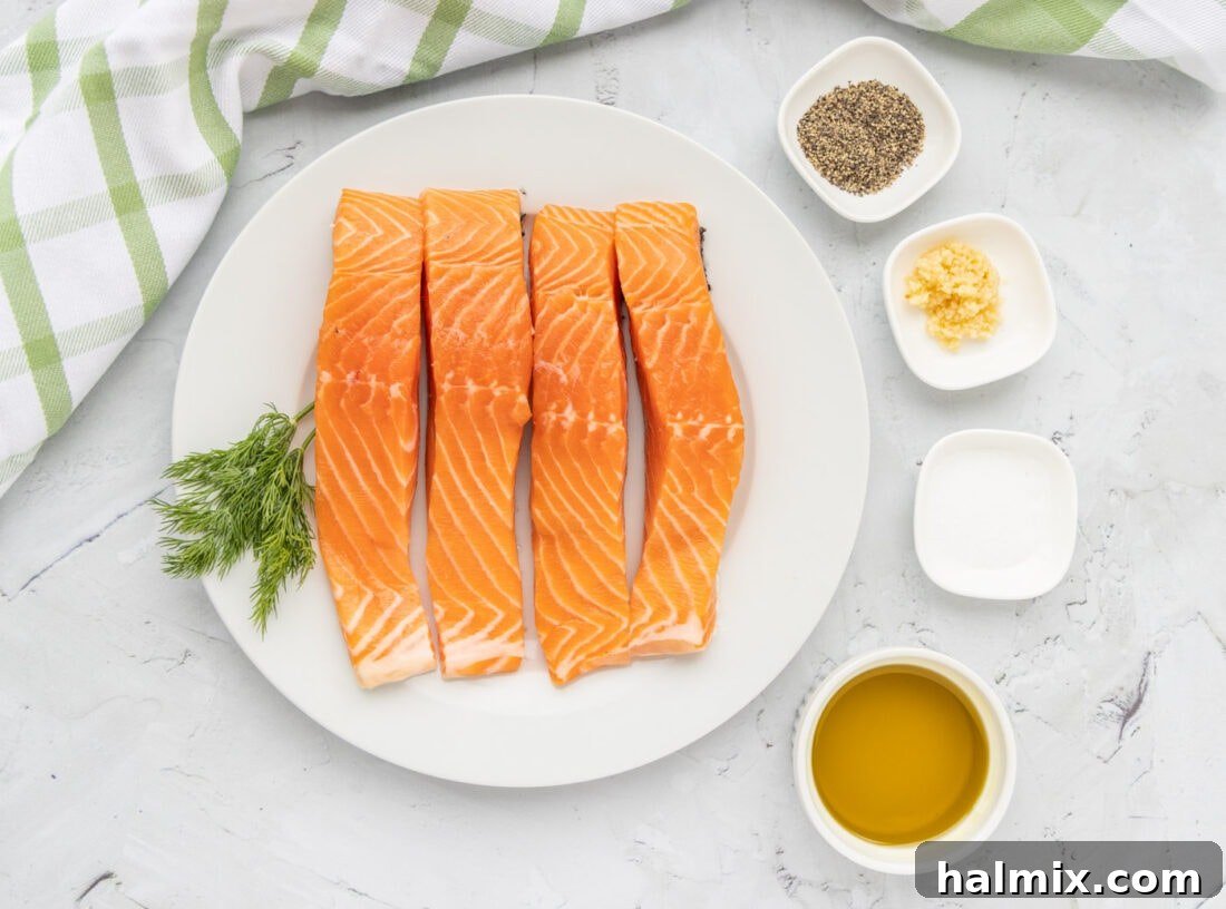 Perfectly Golden Seared Salmon 4 Ingredients for Pan Seared Salmon laid out on a cutting board