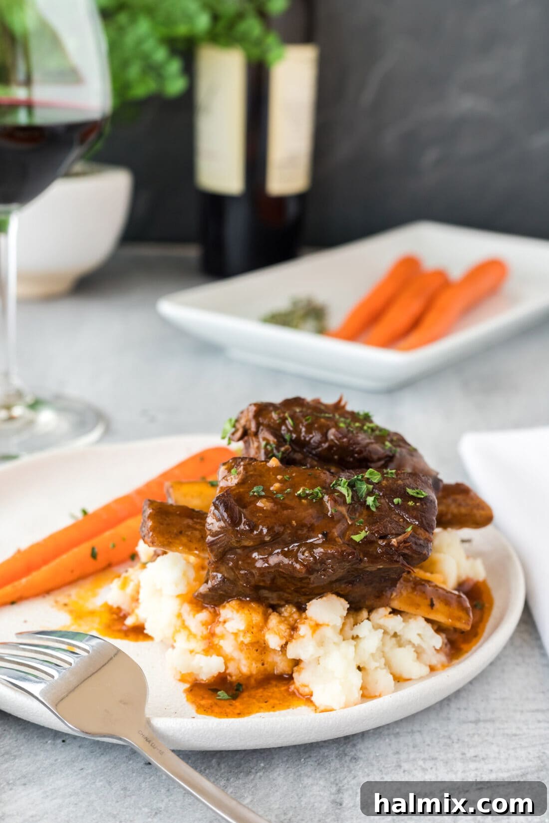 Instant Pot Beef Short Ribs on a plate with gravy and mashed potatoes