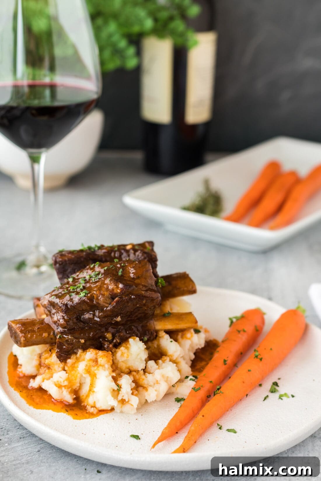 Instant Pot Beef Short Ribs on a plate with potatoes and asparagus