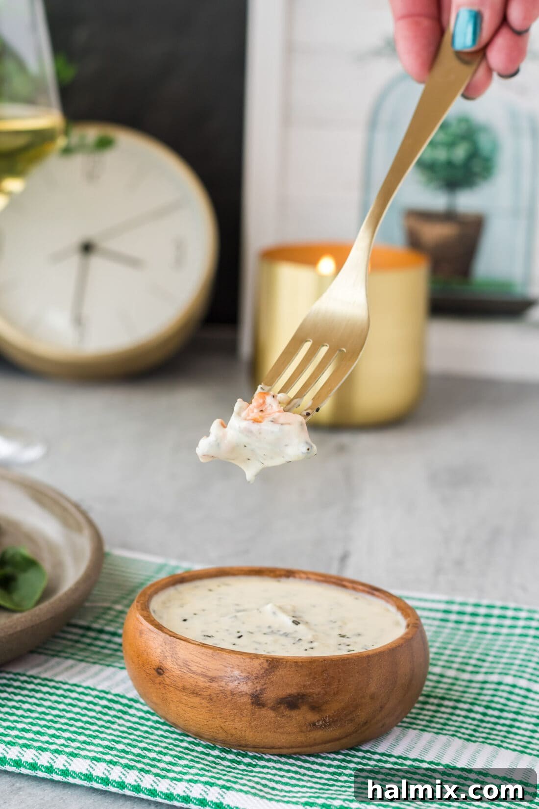 Velvet Rosemary Cream 6 A fork piercing a piece of salmon, dripping with the rich and fragrant Rosemary Cream Sauce, ready to be enjoyed.