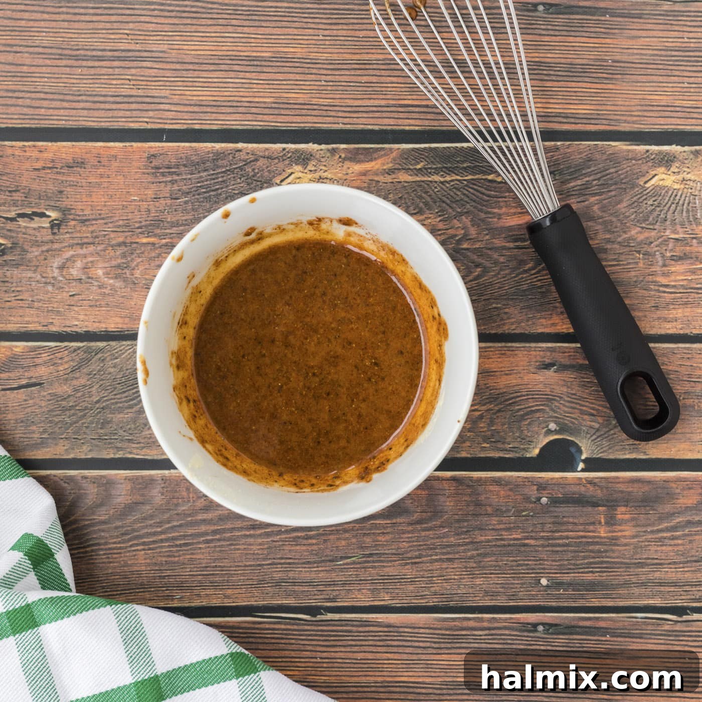 Golden Brown Baked Drumsticks 6 Chicken leg seasoning mixture being whisked in a bowl