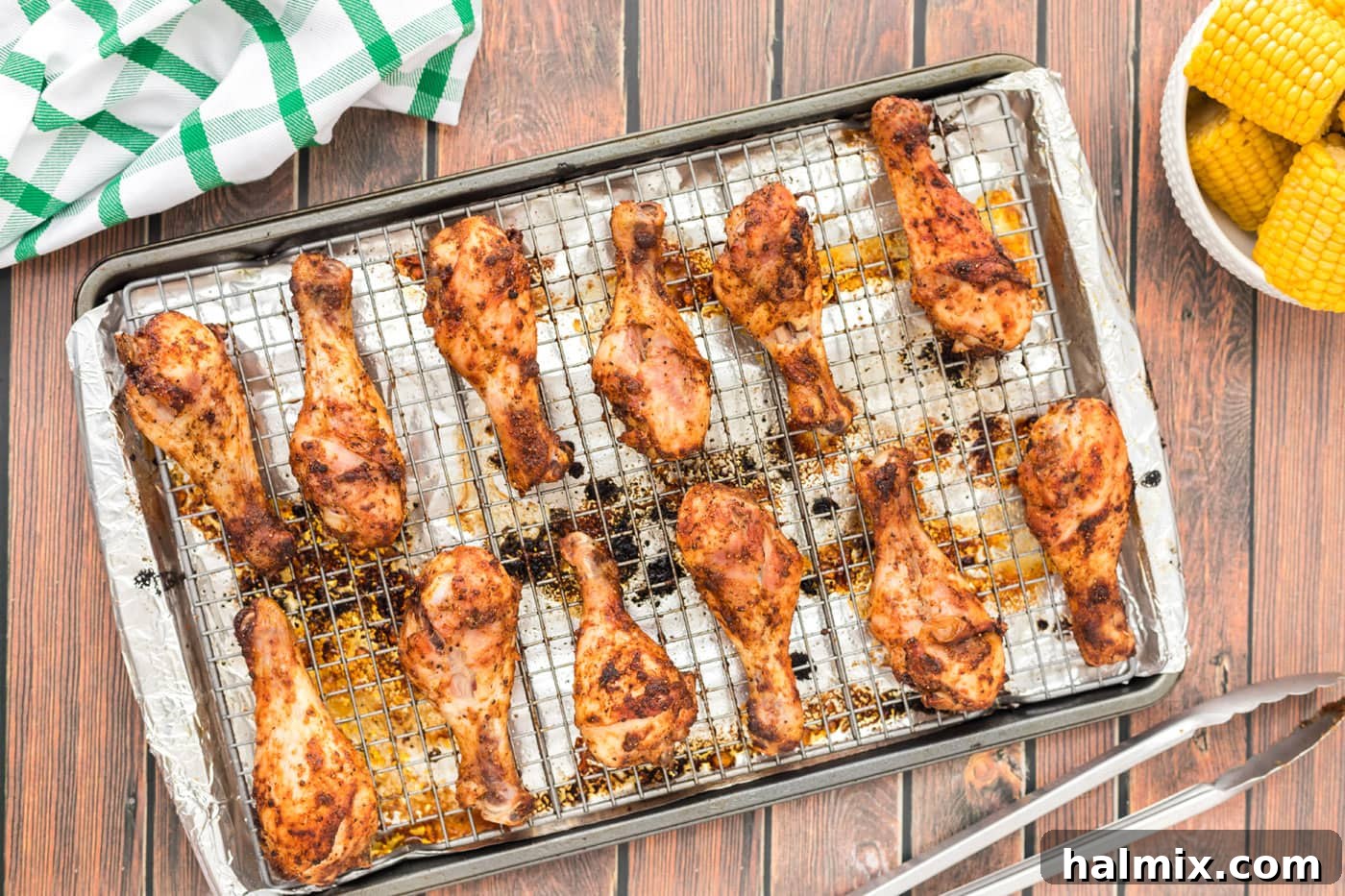 Golden Brown Baked Drumsticks 8 Crispy baked chicken legs resting on a baking sheet after cooking
