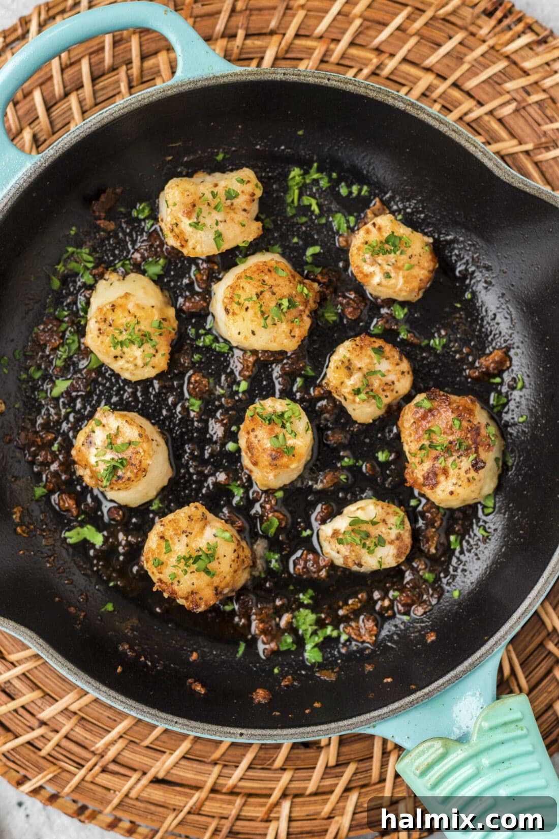 Pan-Seared Scallops cooking in a hot skillet, showing a golden crust forming
