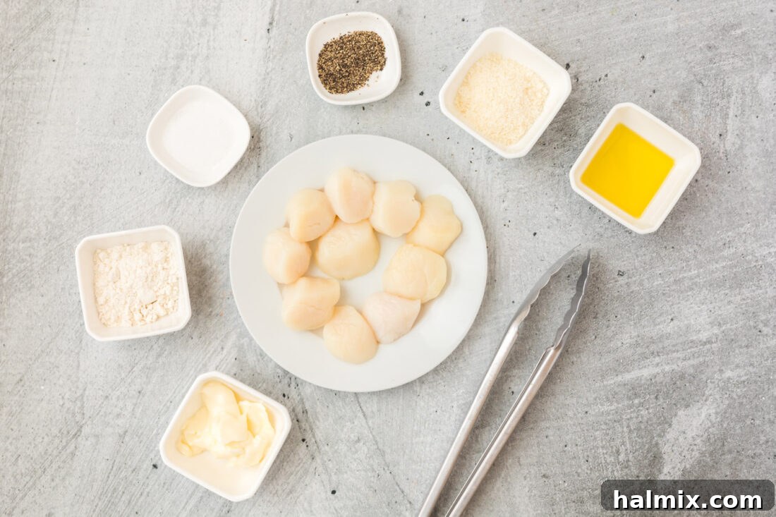 A collection of fresh ingredients laid out for Pan-Seared Scallops, including scallops, butter, flour, and Parmesan