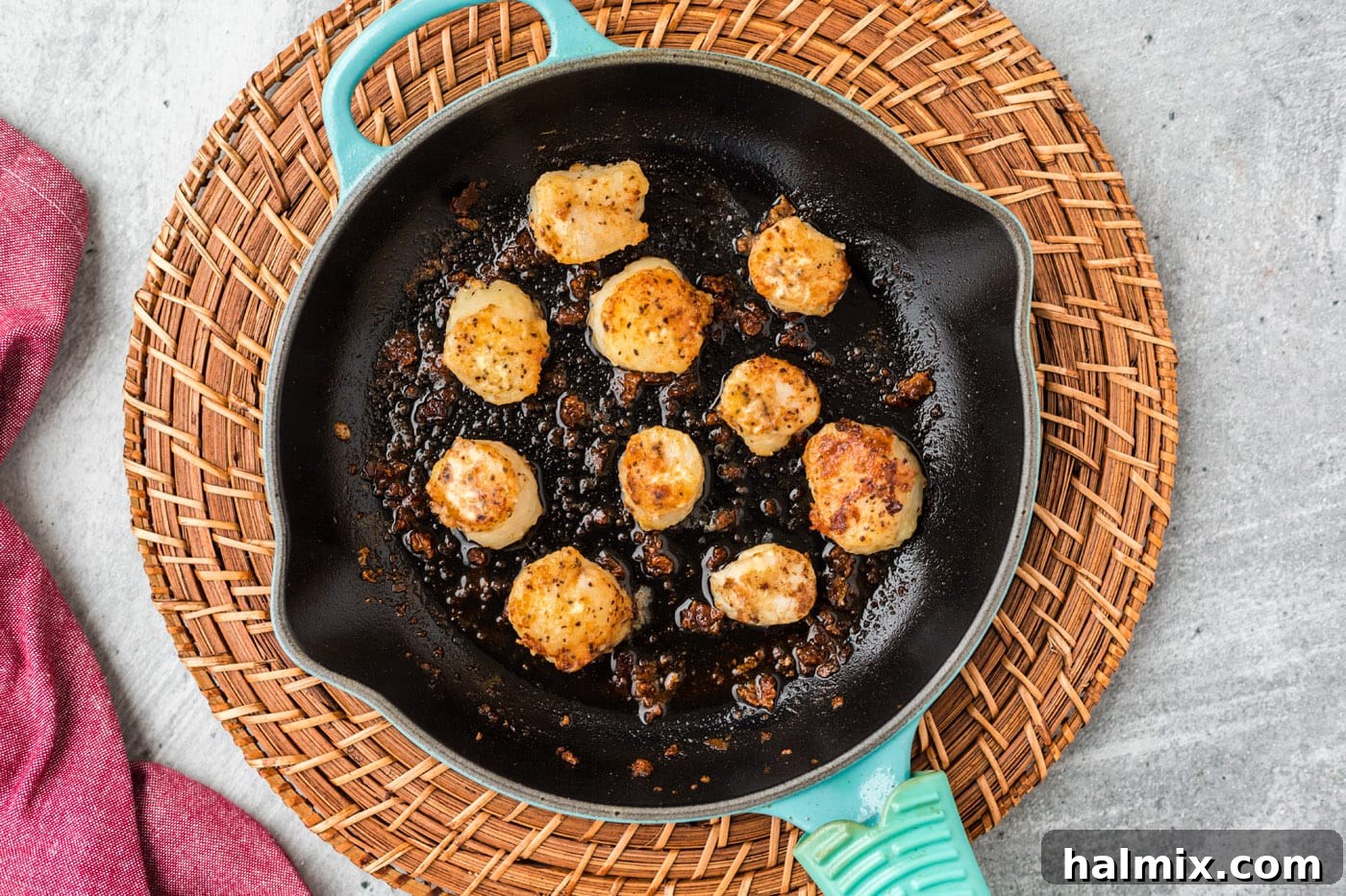 Pan searing scallops in a hot skillet until golden brown