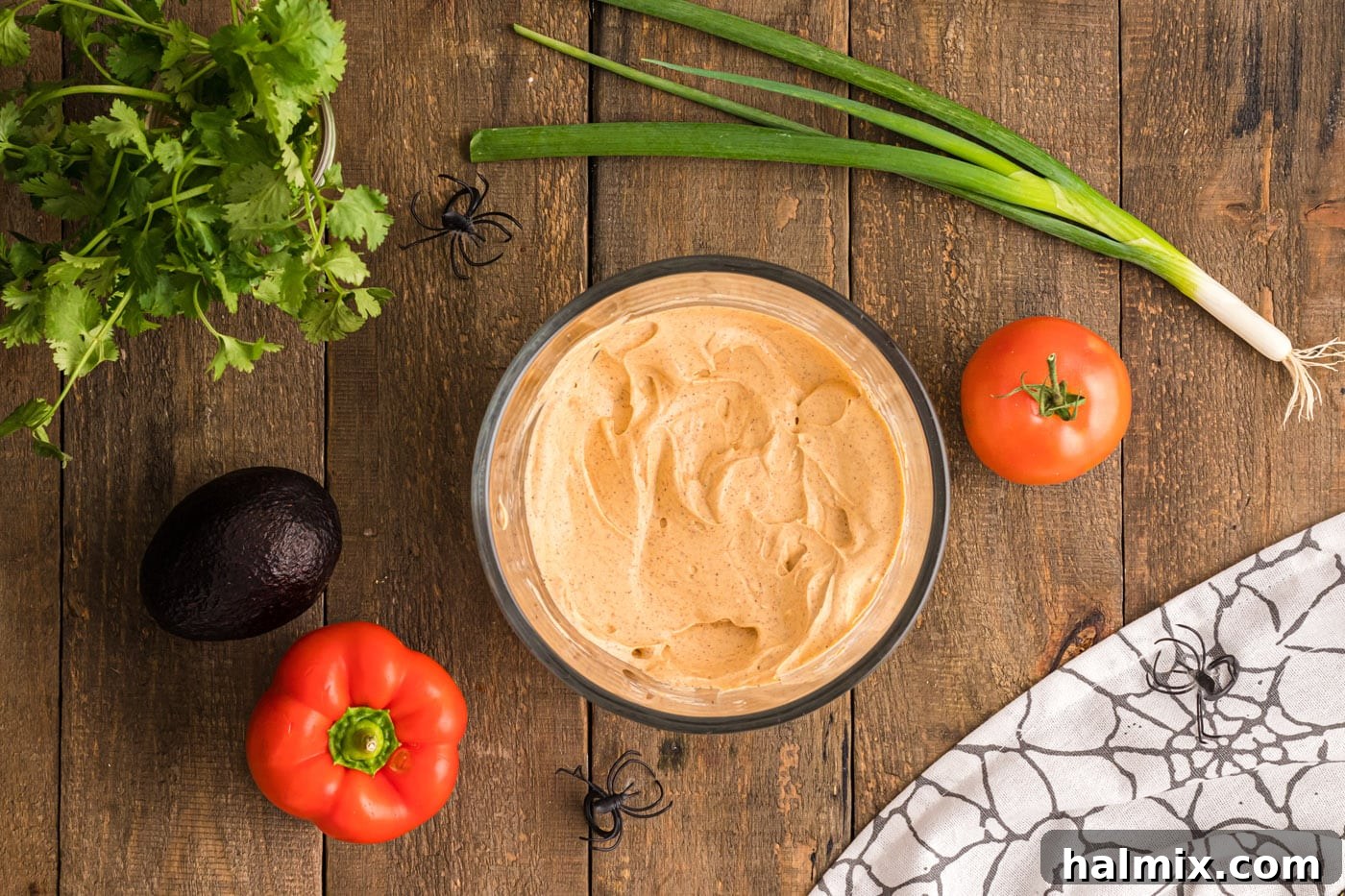A bowl filled with a creamy mixture of sour cream, cream cheese, and taco seasoning, ready to be spread.