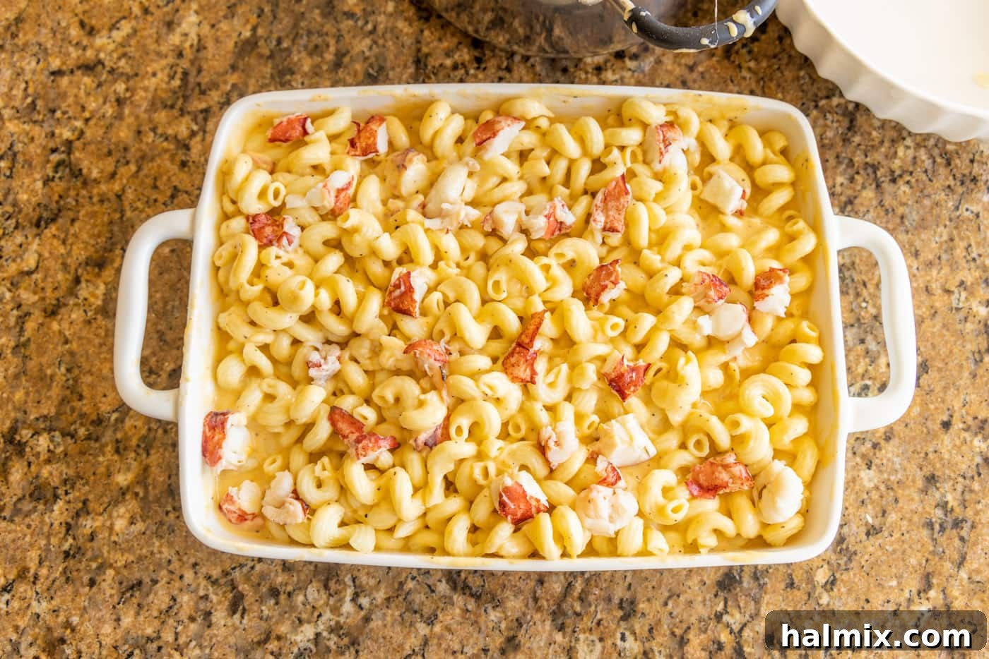 second layer of lobster mac and cheese in a baking dish, ready for topping