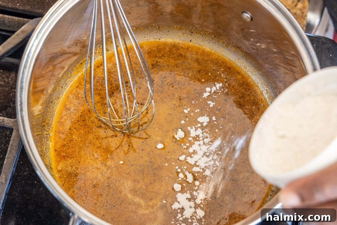 adding flour to butter and spices for a roux base