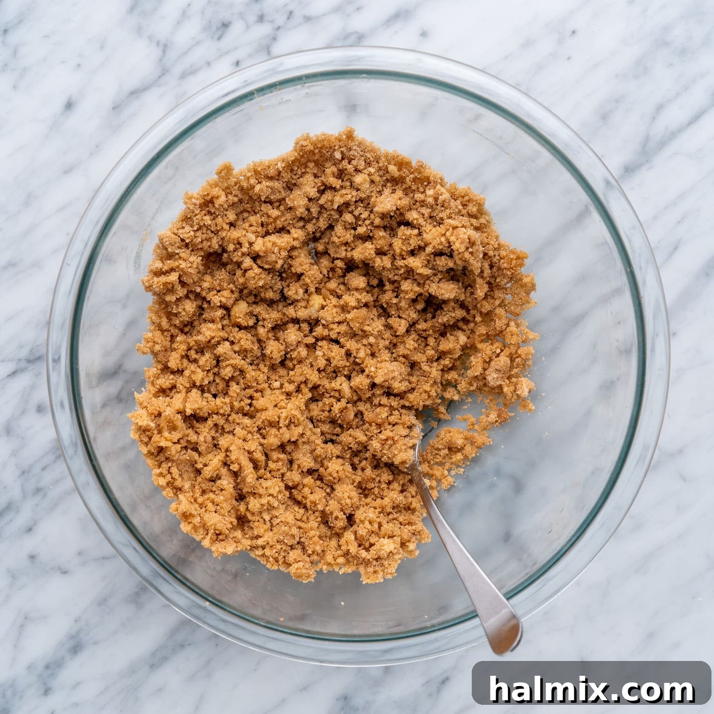 Spiced Apple Caramel Cheesecake Bars 14 streusel topping mixed in a bowl