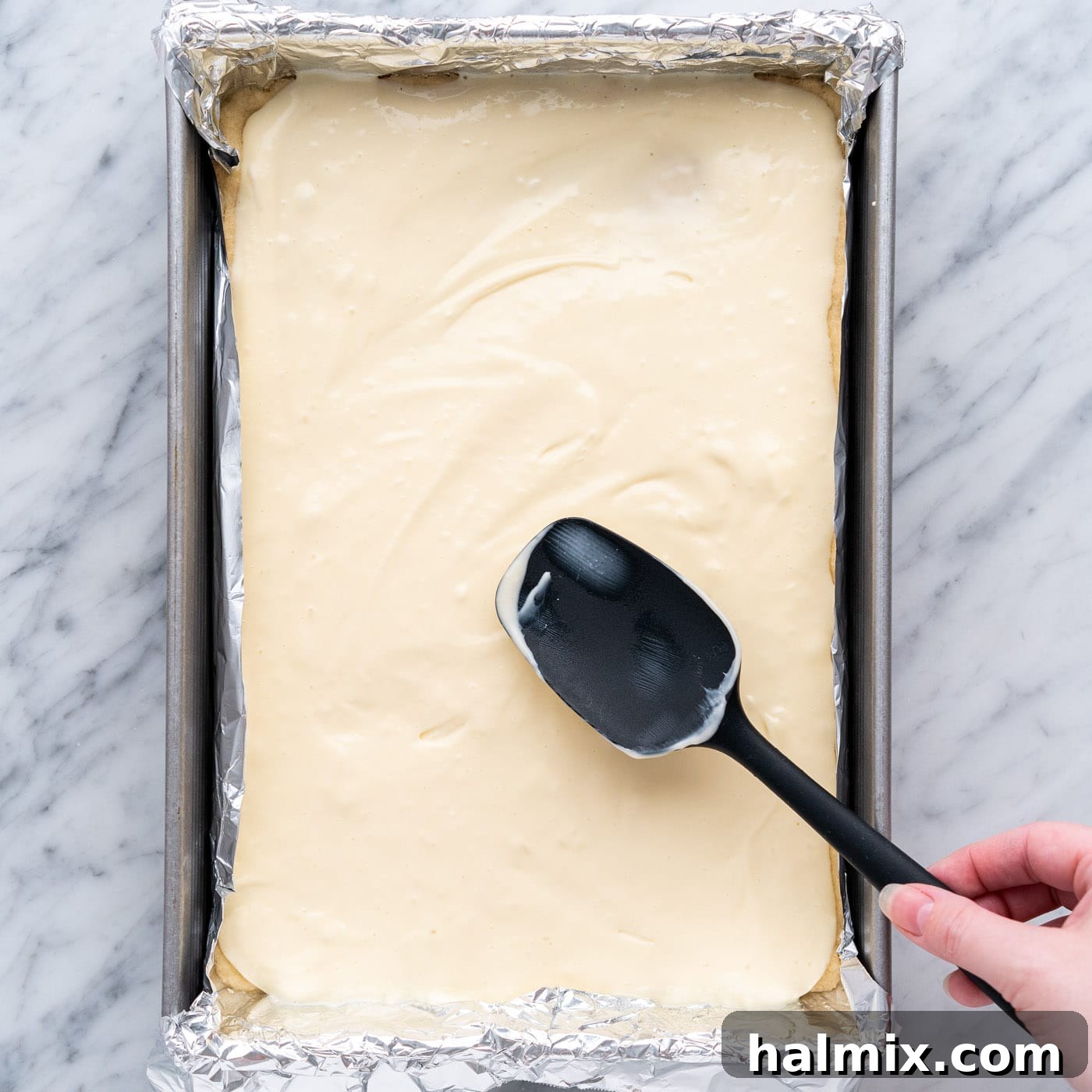 Spiced Apple Caramel Cheesecake Bars 16 spreading cheesecake mixture over shortbread crust