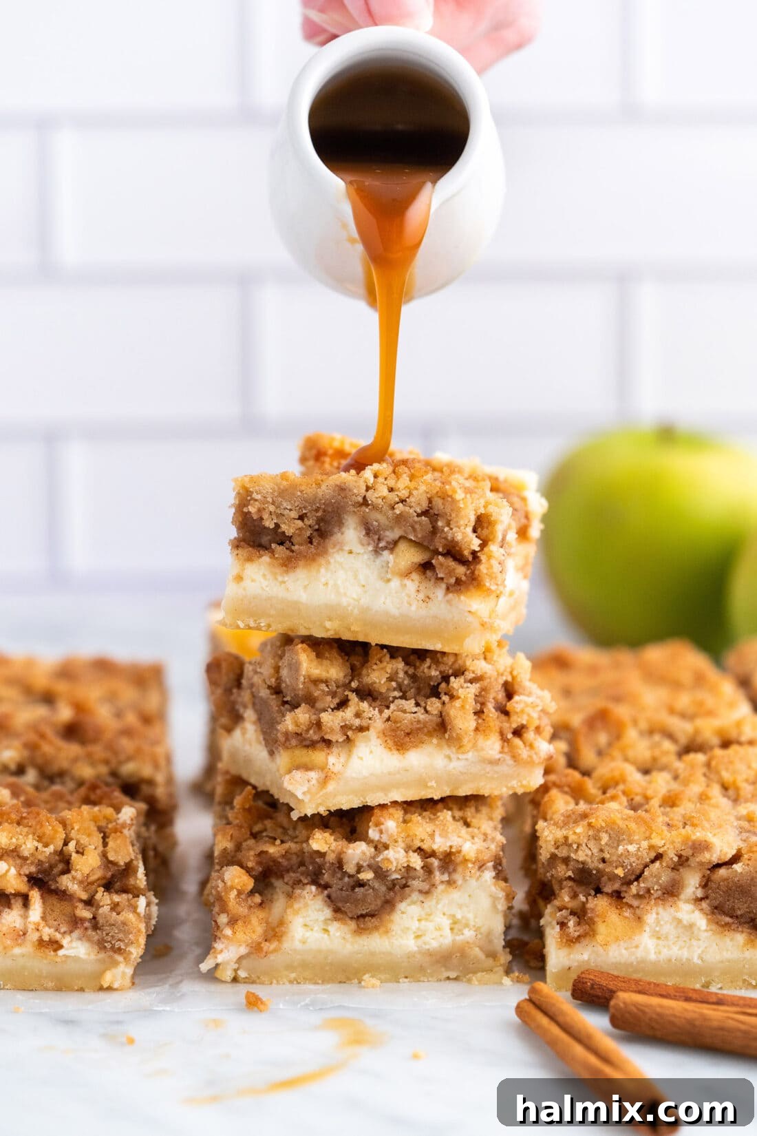 Spiced Apple Caramel Cheesecake Bars 19 dripping caramel onto Caramel Apple Cheesecake Bars