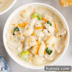 A close-up of creamy chicken gnocchi soup with a perfect blend of ingredients, ideal for a comforting meal.
