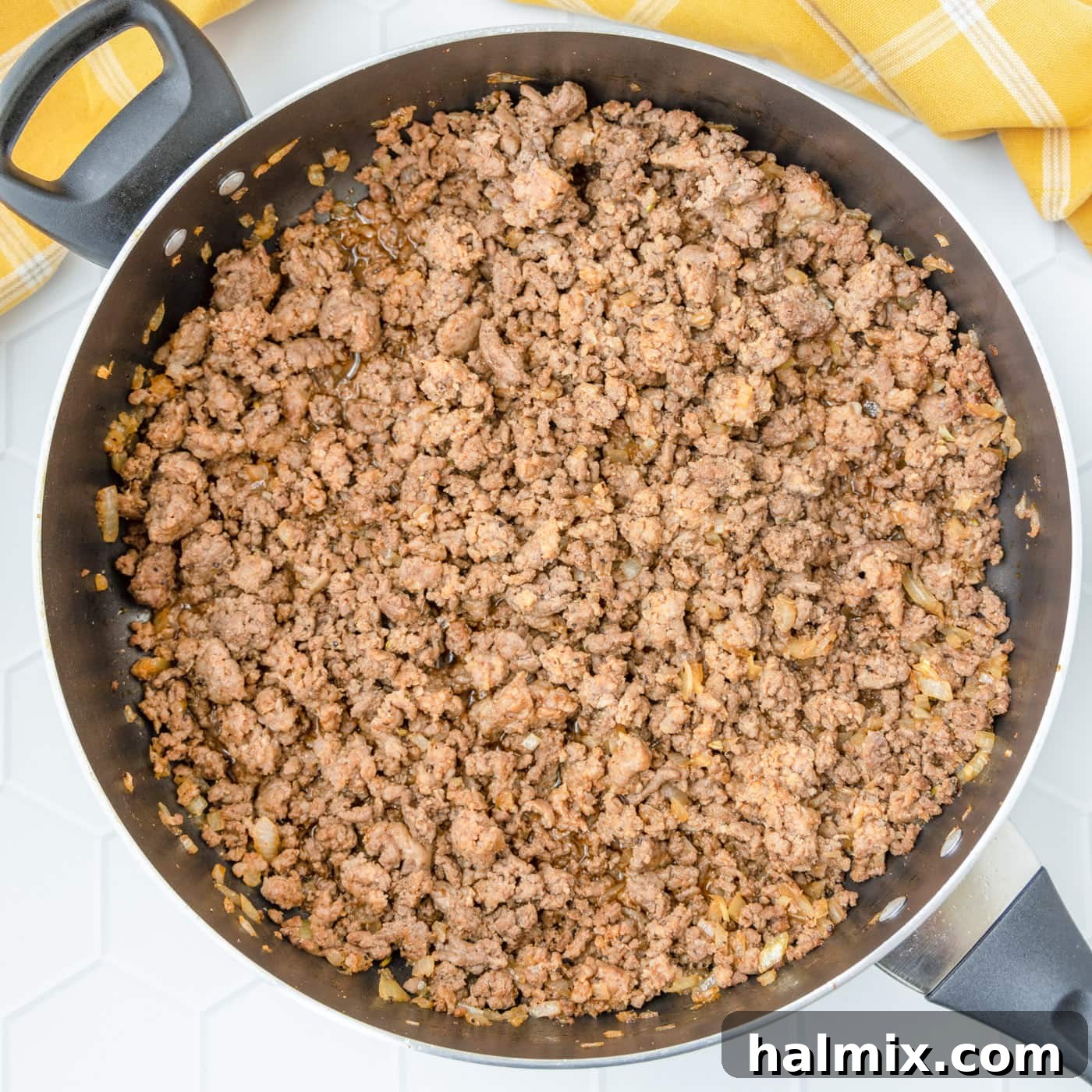 Ground beef and Italian sausage fully browned and ready in a skillet for the next steps