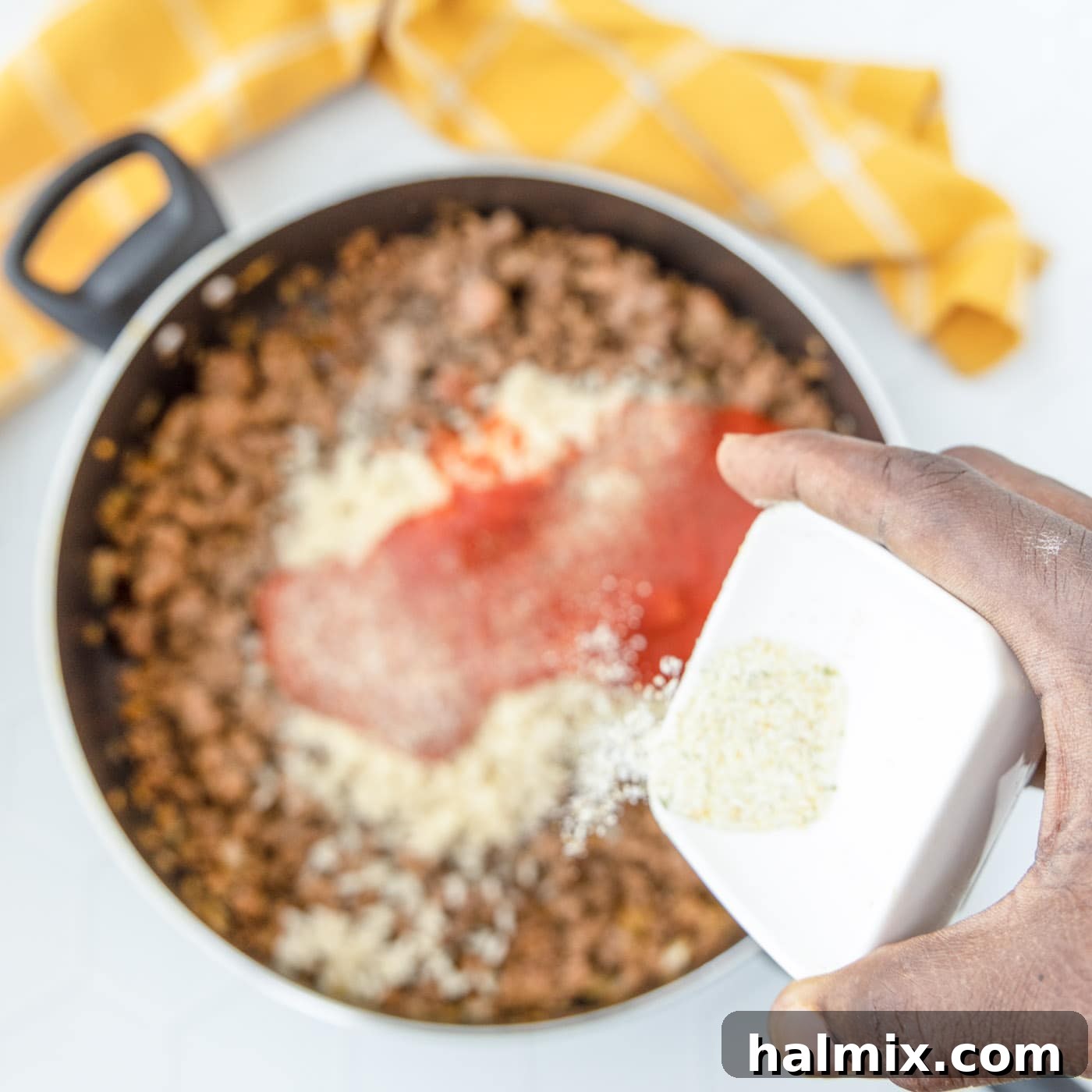 Savory Stuffed Peppers 8 Pouring garlic salt over the seasoned meat mixture in skillet
