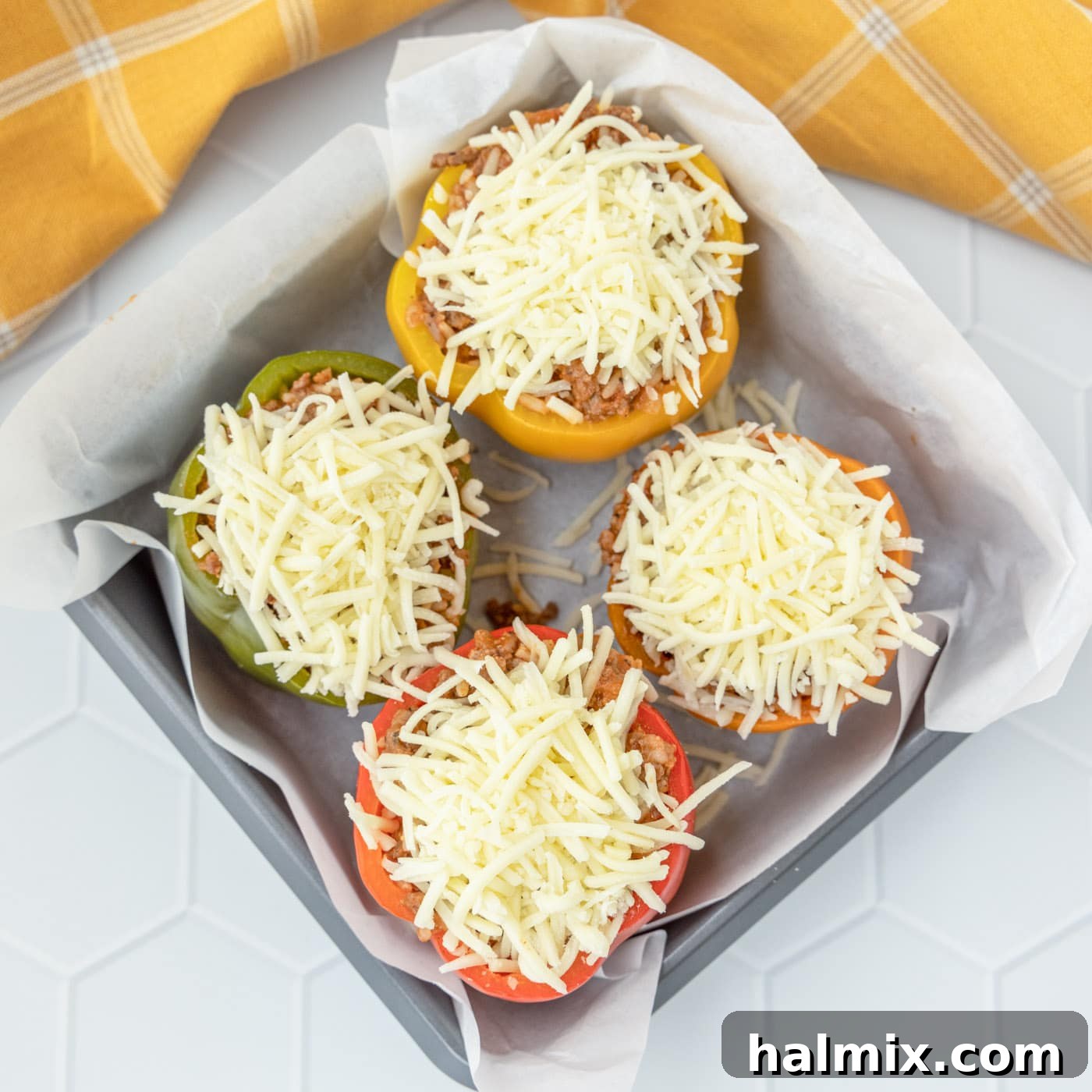 Savory Stuffed Peppers 10 Stuffed peppers with cheese in a baking dish, perfectly layered and ready for the oven
