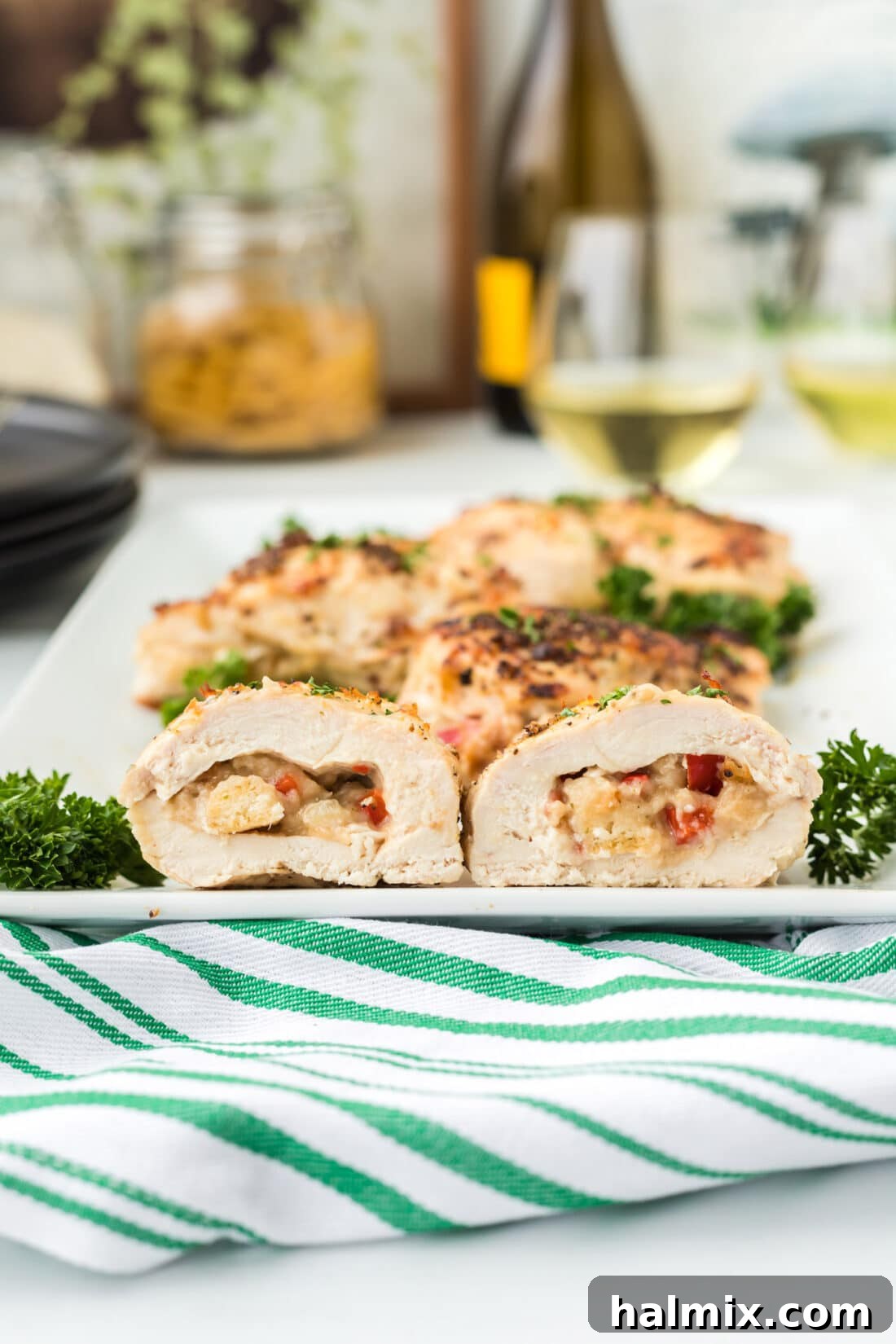 Perfectly Stuffed Chicken Roulade 2 Stuffed Chicken Breast sliced in half on platter, revealing a savory filling