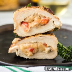 Stuffed Chicken Breast on a black plate, showcasing its golden exterior