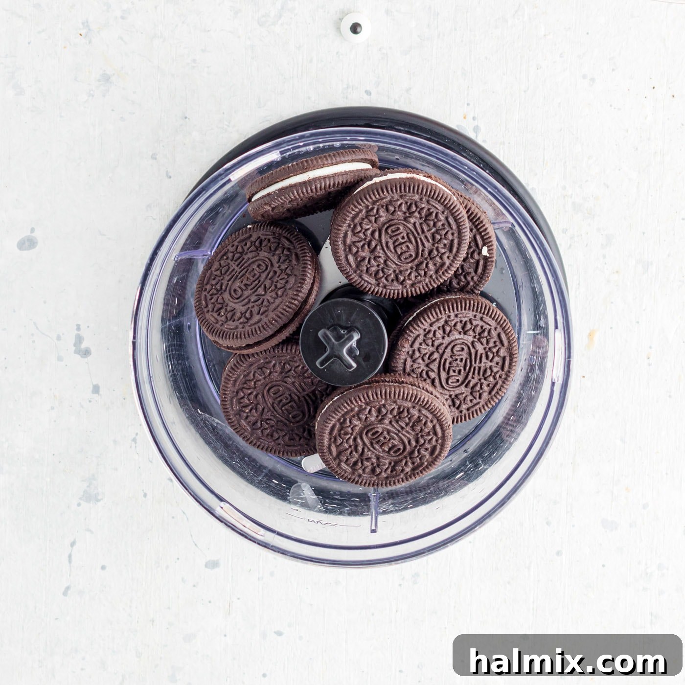 Oreo cookies placed in the base of a food processor, ready to be crushed into 'dirt' crumbs.
