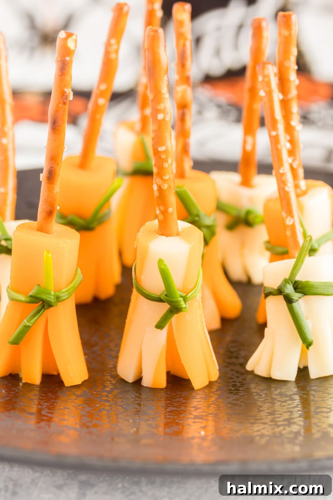 Cheesy Pretzel Broomsticks 2 A festive tray of cheese and pretzel broomsticks ready for a Halloween party.