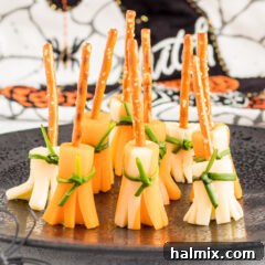 A close-up of a cheese and pretzel broomstick, highlighting its details and festive appeal.
