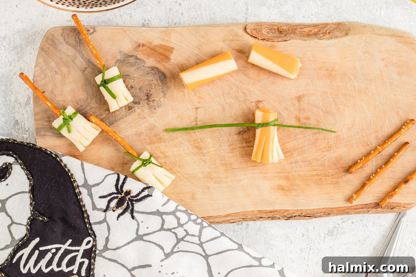 Cheesy Pretzel Broomsticks 8 A cheese broomstick with the chive neatly tied and secured, ready for the pretzel handle.