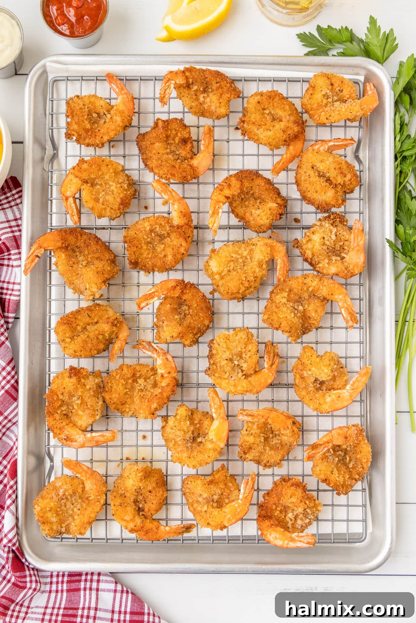 Crispy butterfly shrimp frying in a pan, turning golden brown