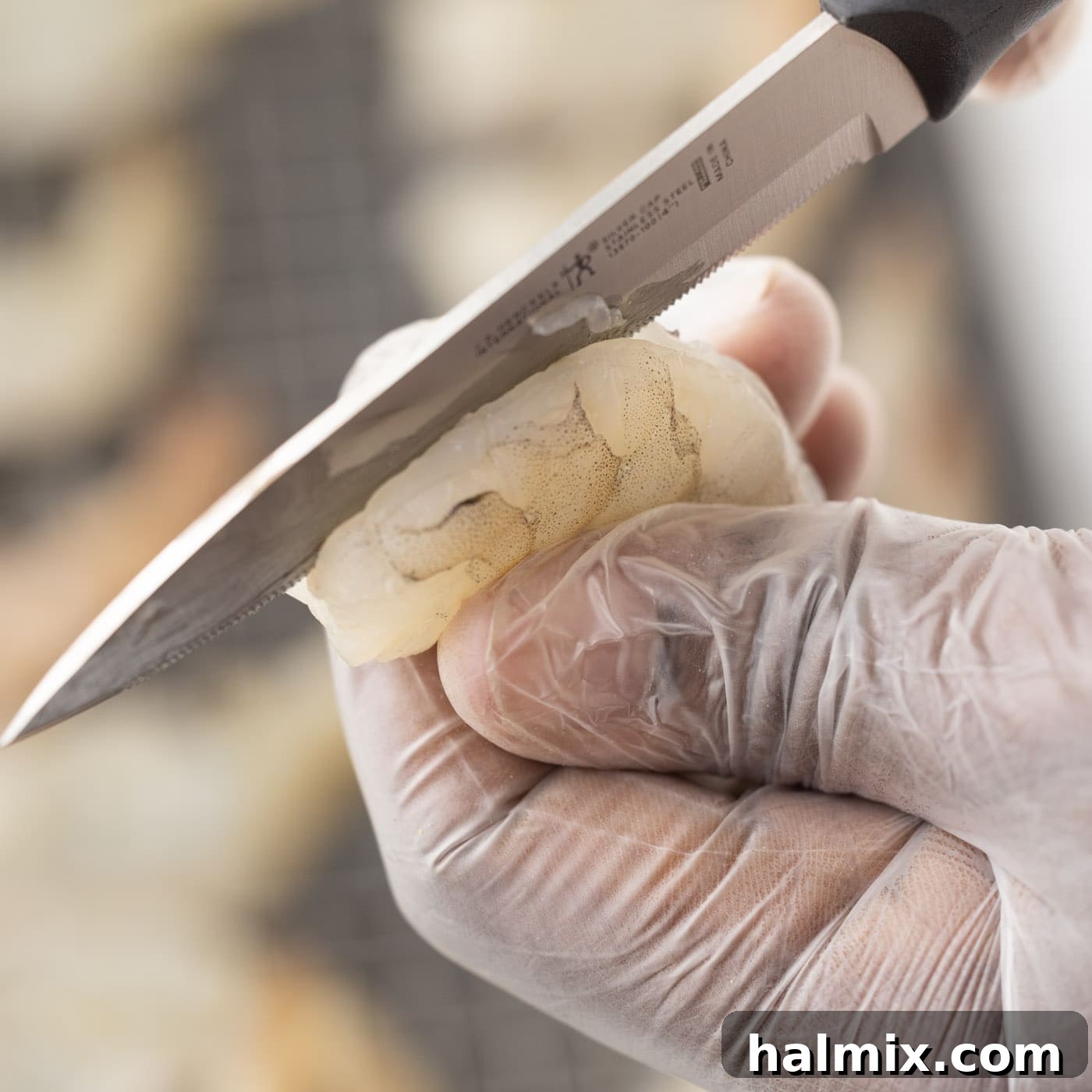 Step-by-step image showing how to butterfly shrimp with a knife