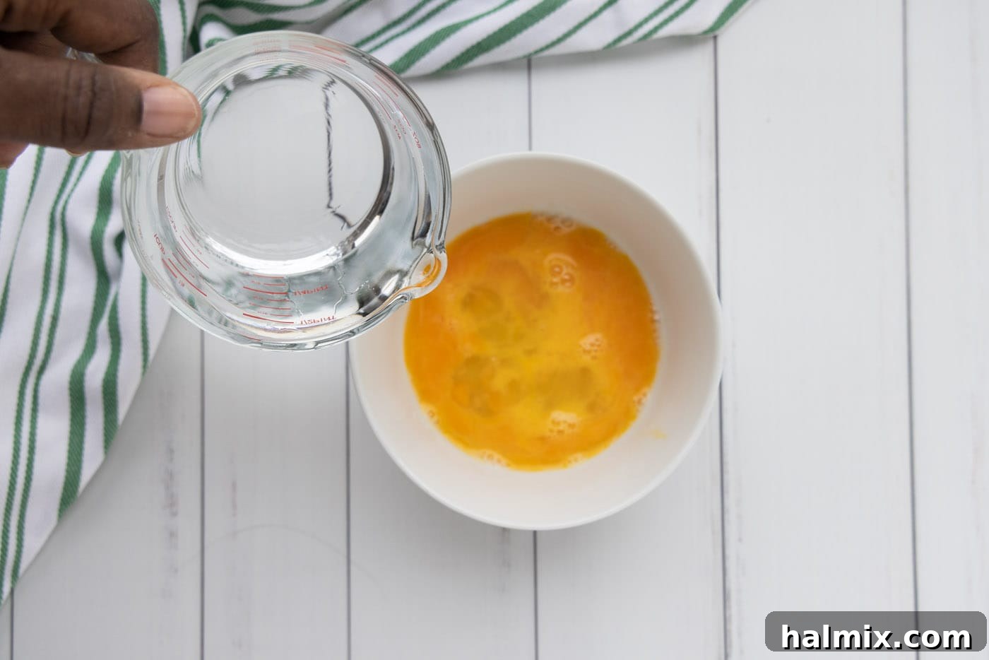 Bowl with whisked eggs and water, ready for the egg wash