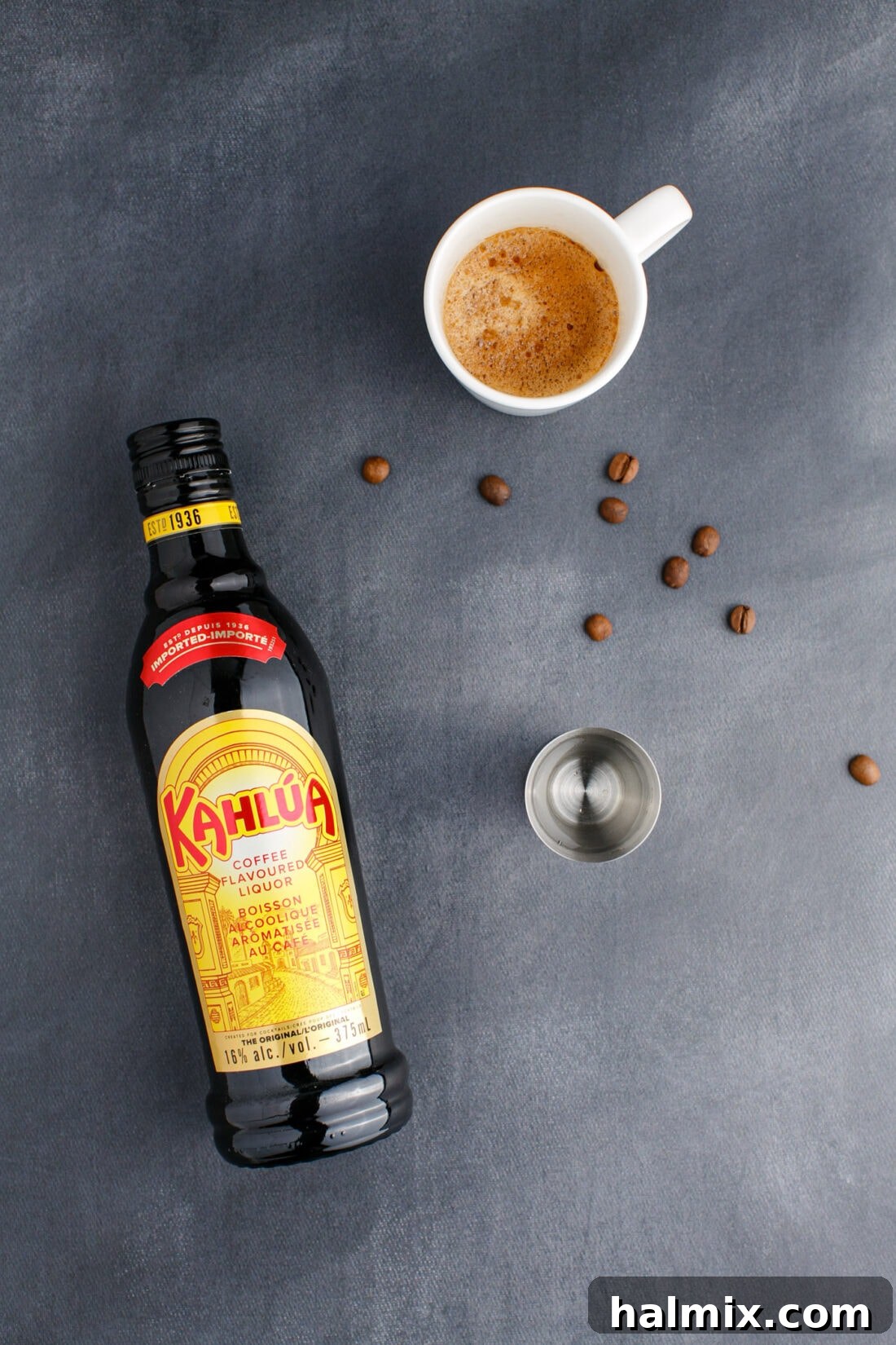 Various ingredients for an Espresso Martini, including espresso, a bottle of vodka, and coffee liqueur, neatly arranged.