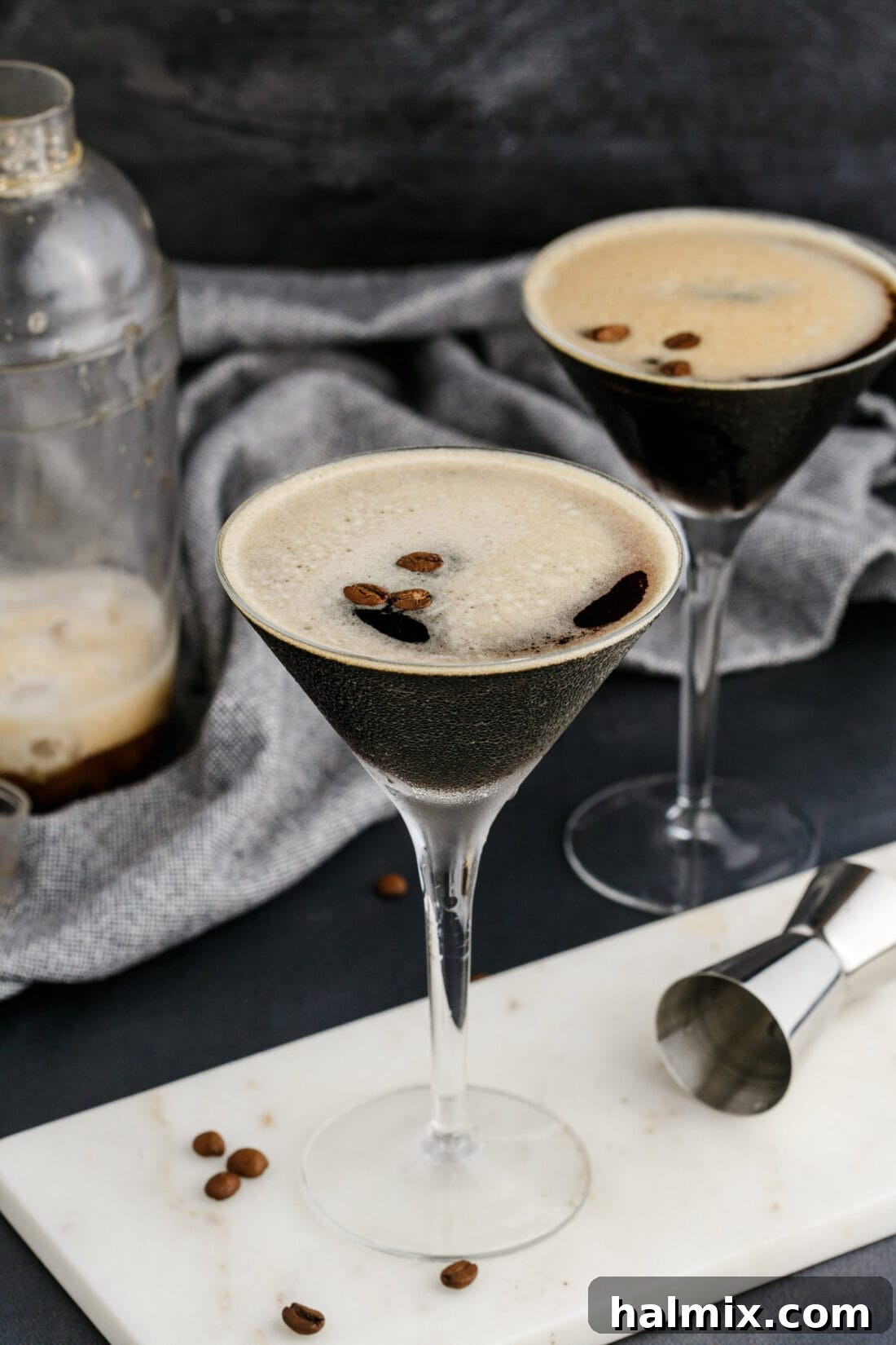 Two expertly crafted Espresso Martinis, garnished with three coffee beans each, ready for enjoyment.