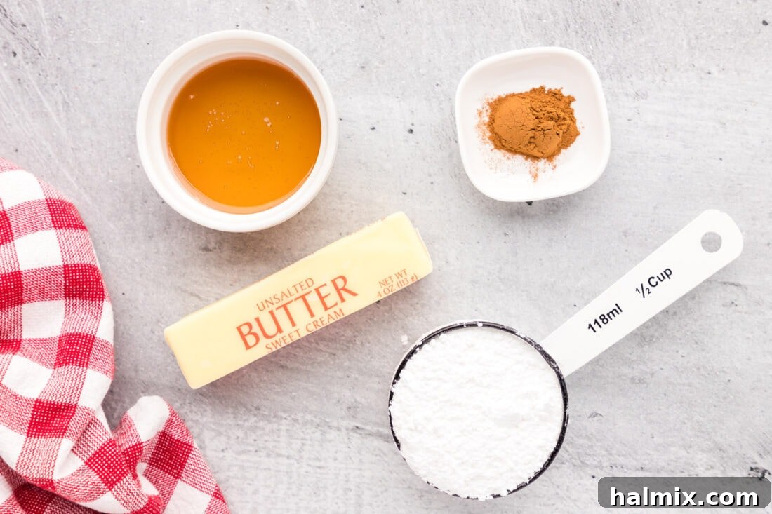 Ingredients laid out for Cinnamon Honey Butter recipe, including butter, honey, powdered sugar, and cinnamon