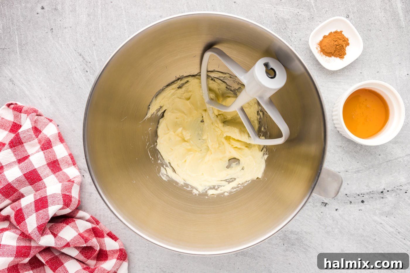 Softened butter being beaten until creamy in a stand mixer bowl