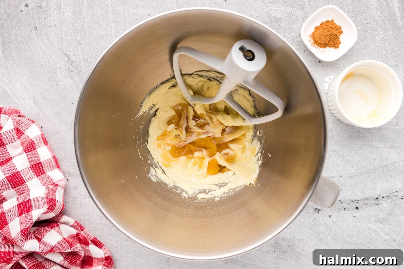Honey being mixed with creamy butter in a stand mixer bowl