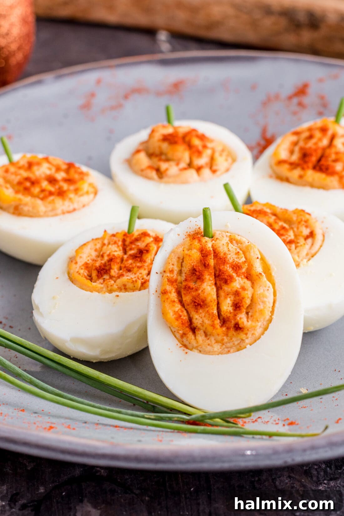 Spiced Pumpkin Deviled Bites 2 Festive Pumpkin Deviled Eggs on a serving plate, perfect for fall parties