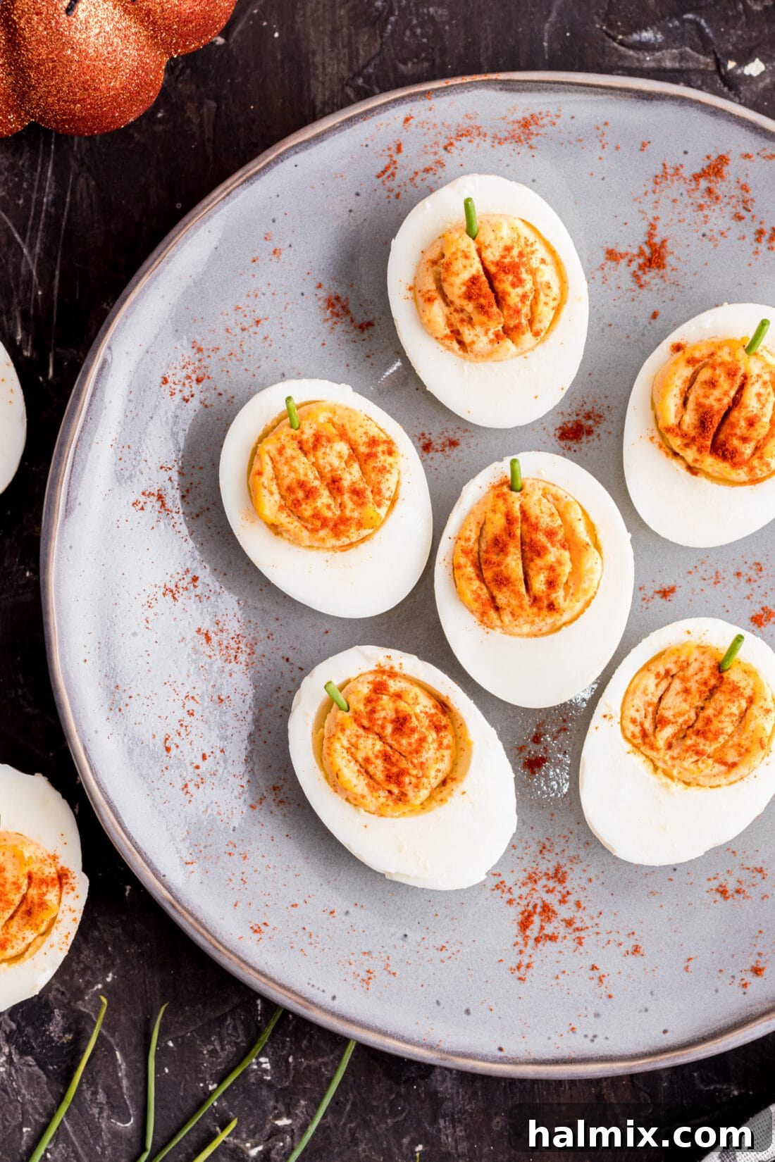 Spiced Pumpkin Deviled Bites 3 Close-up of a plate of adorable pumpkin-shaped deviled eggs, ready for serving