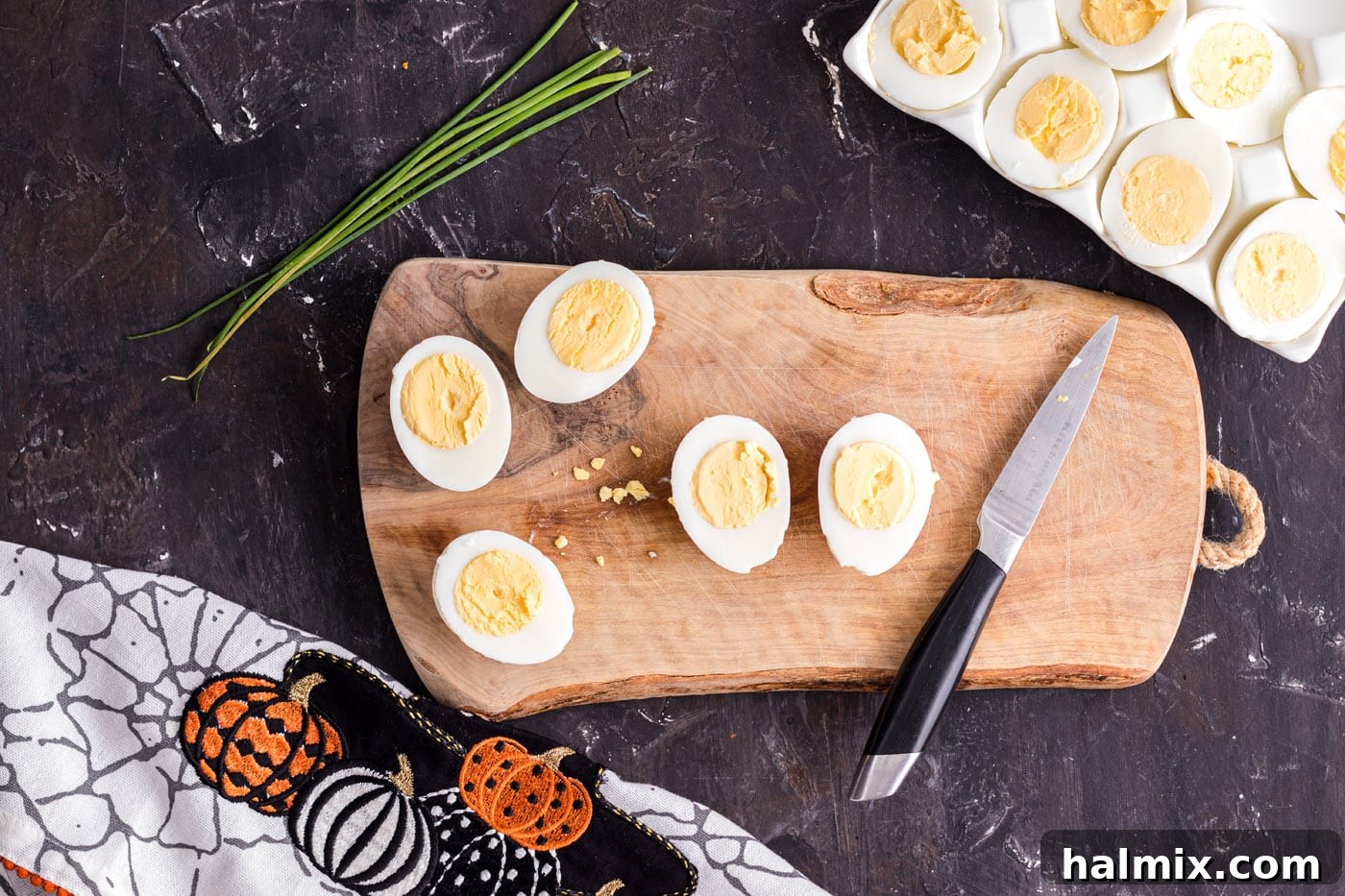 Spiced Pumpkin Deviled Bites 5 Hard boiled eggs sliced in half, ready for yolk removal