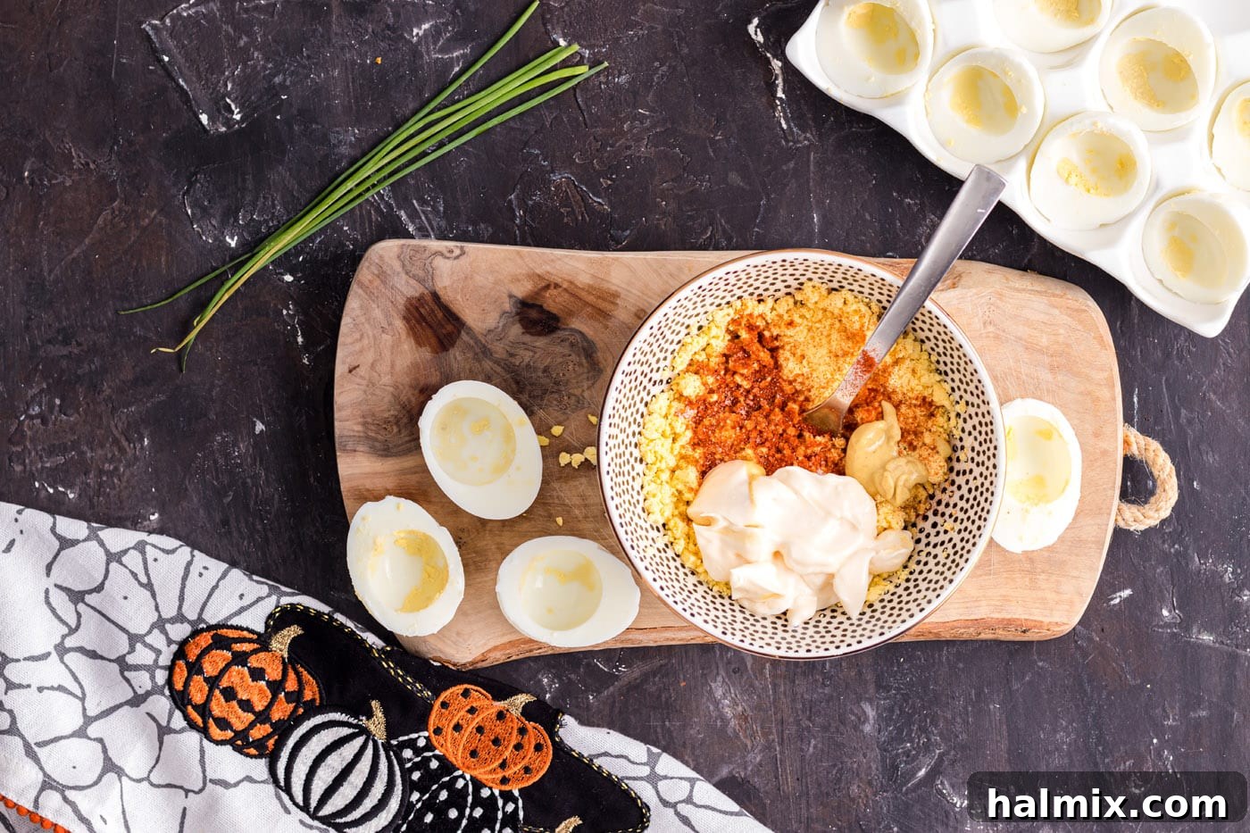 Spiced Pumpkin Deviled Bites 6 Mashing deviled egg ingredients in a bowl, showing the creamy texture